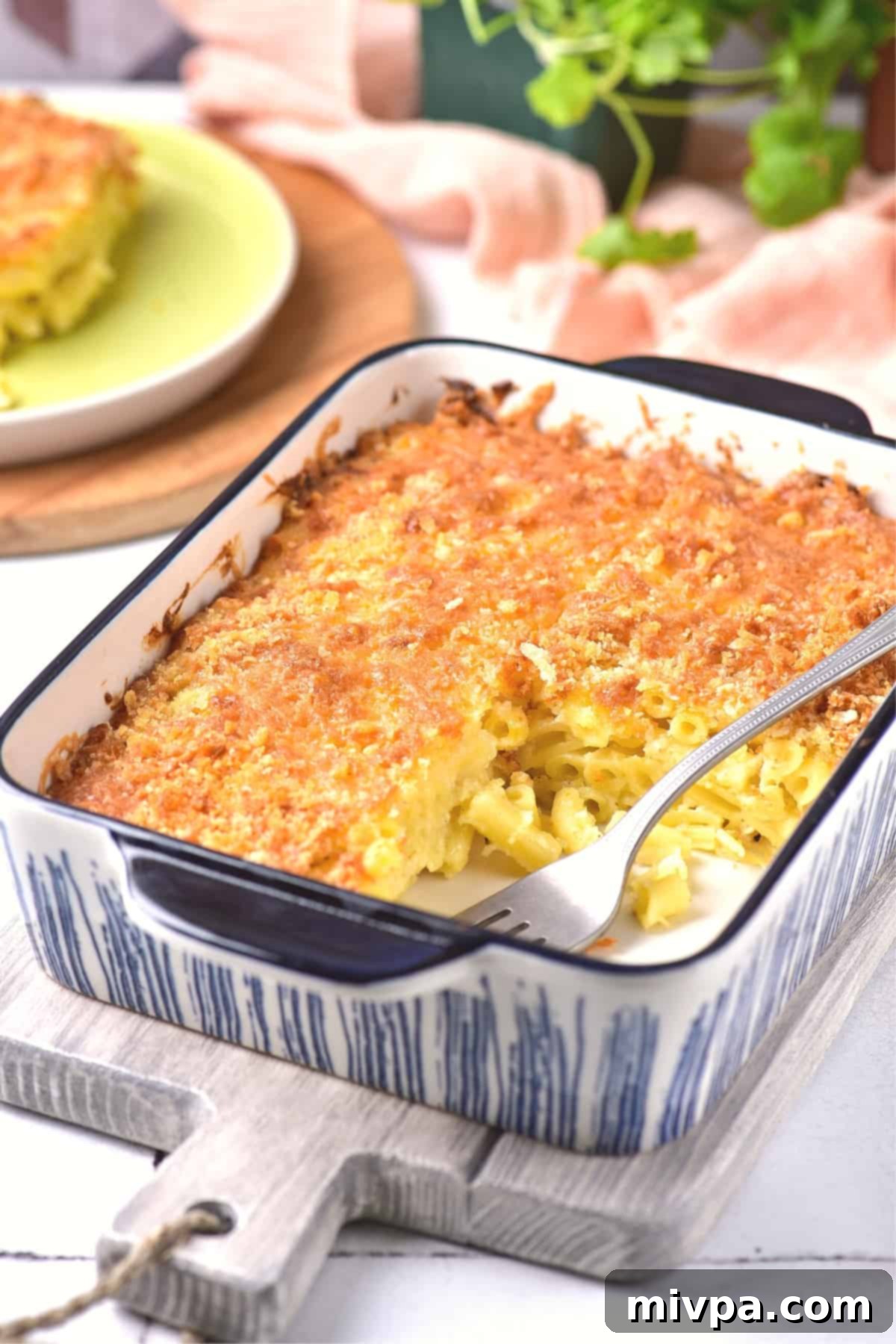 A fork in a casserole dish with mac and cheese.