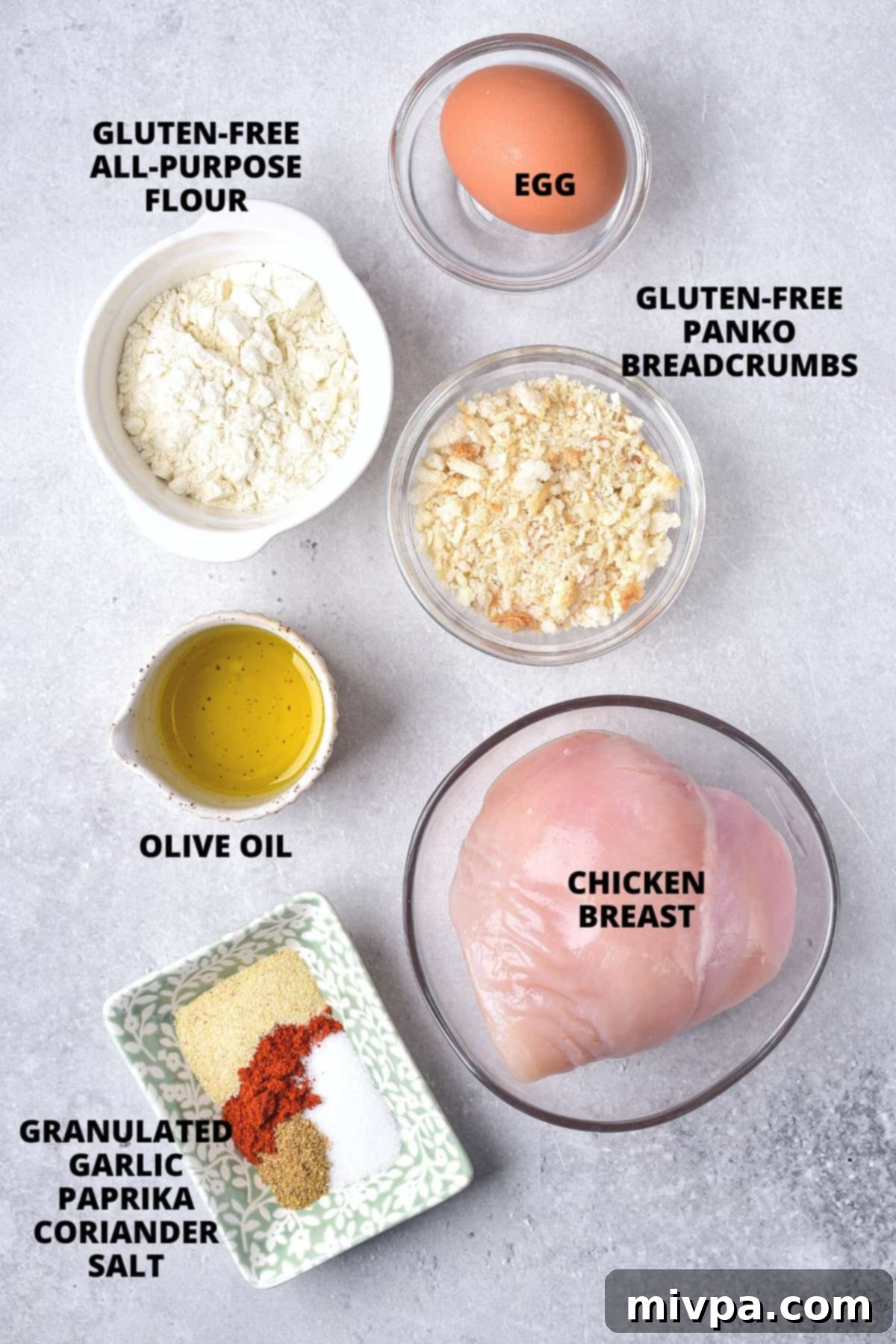 Ingredients for gluten-free air fryer chicken cutlets laid out on board.
