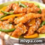 Up close shot of a plate of gluten-free honey sesame chicken.