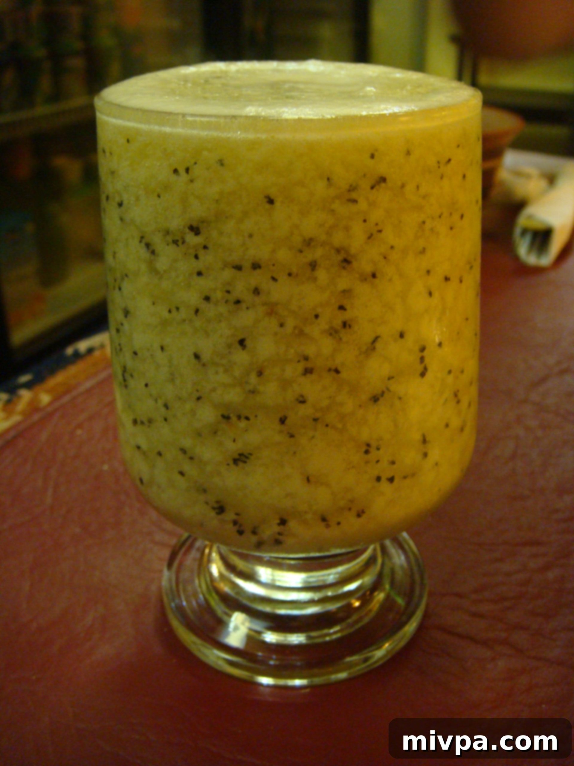 DSC05797 A vibrant passion fruit Pisco Sour cocktail, garnished with passion fruit seeds.