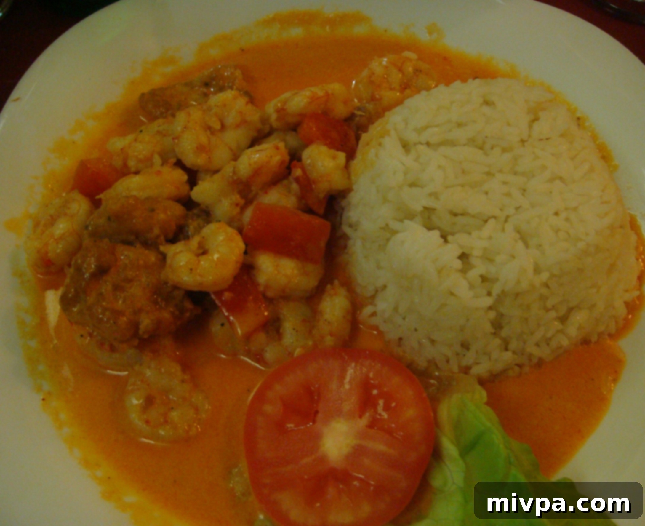 DSC05799 A plate of Camarones Ajillo, spicy garlic shrimp, served with fried fish and white rice.