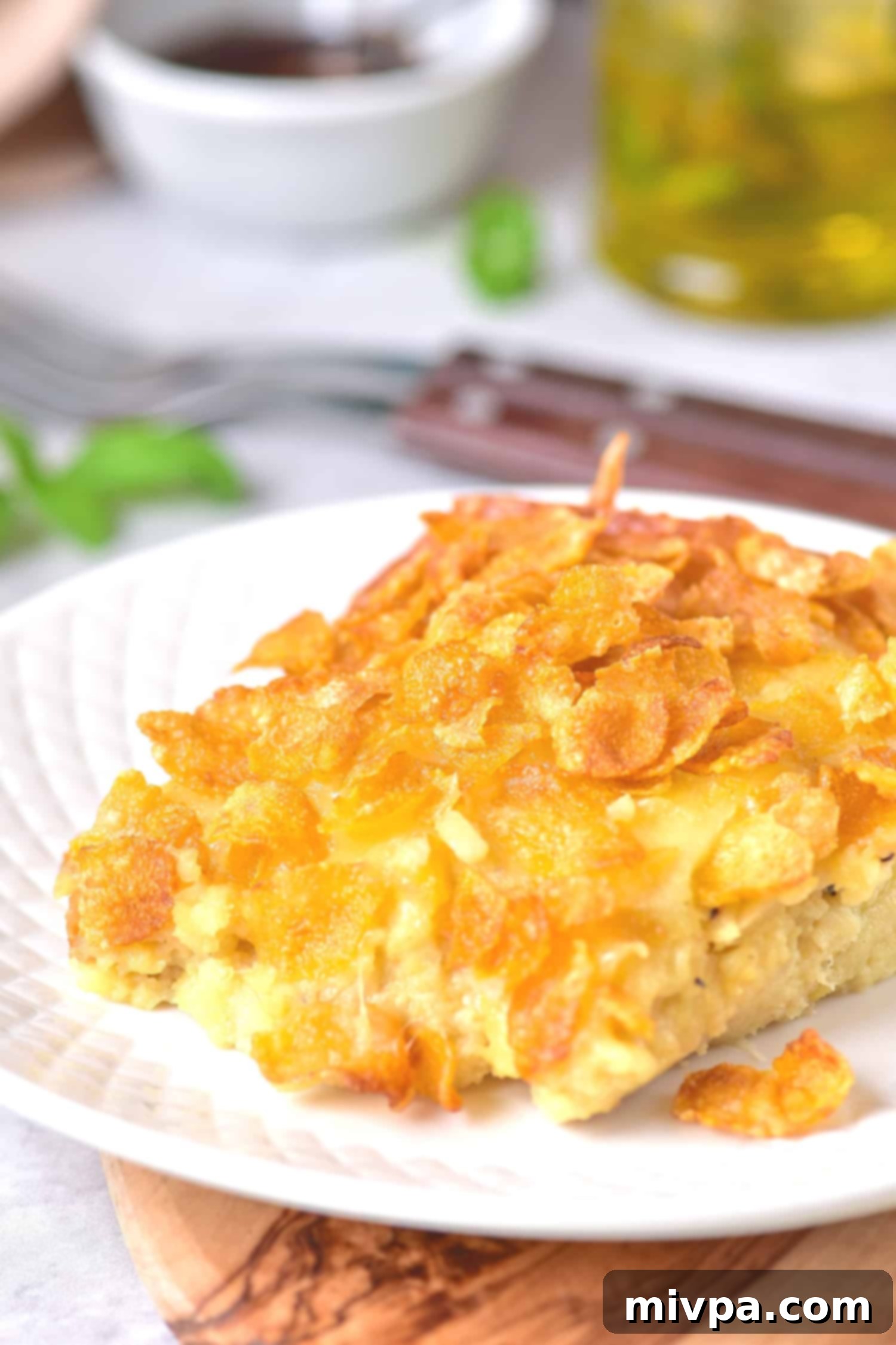 A plate of gluten free hash brown casserole, showing the creamy interior and crispy topping.