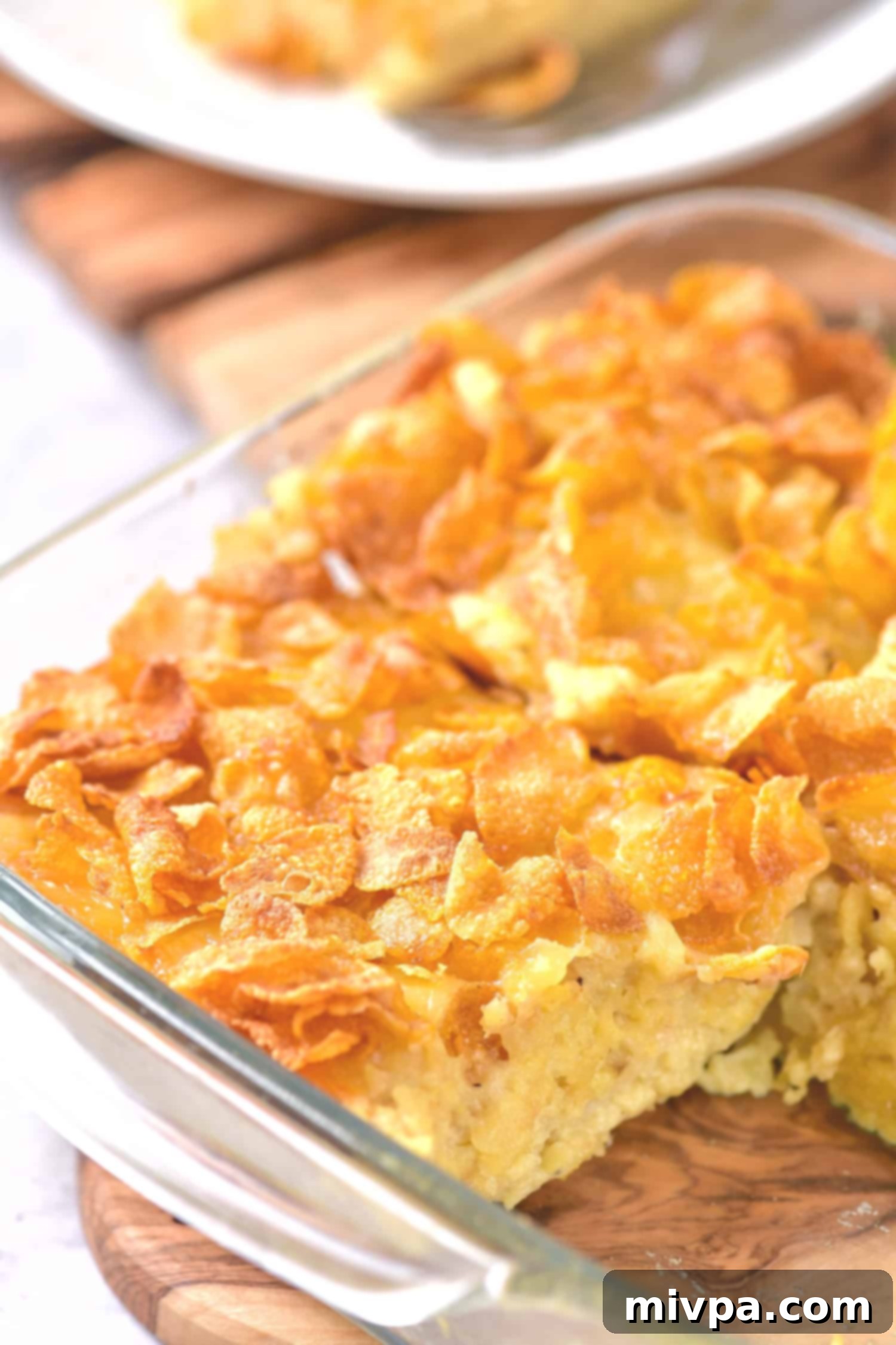 Half-eaten dairy-free hashbrown casserole in a baking dish, ready to be served.