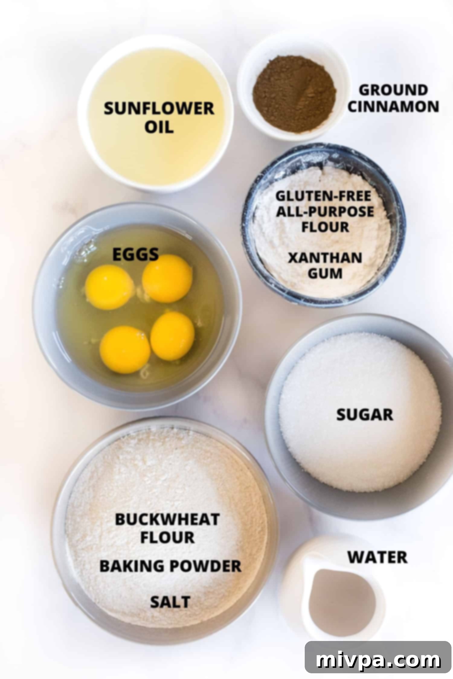 Ingredients for buckwheat muffins recipe neatly laid out on a marble board.