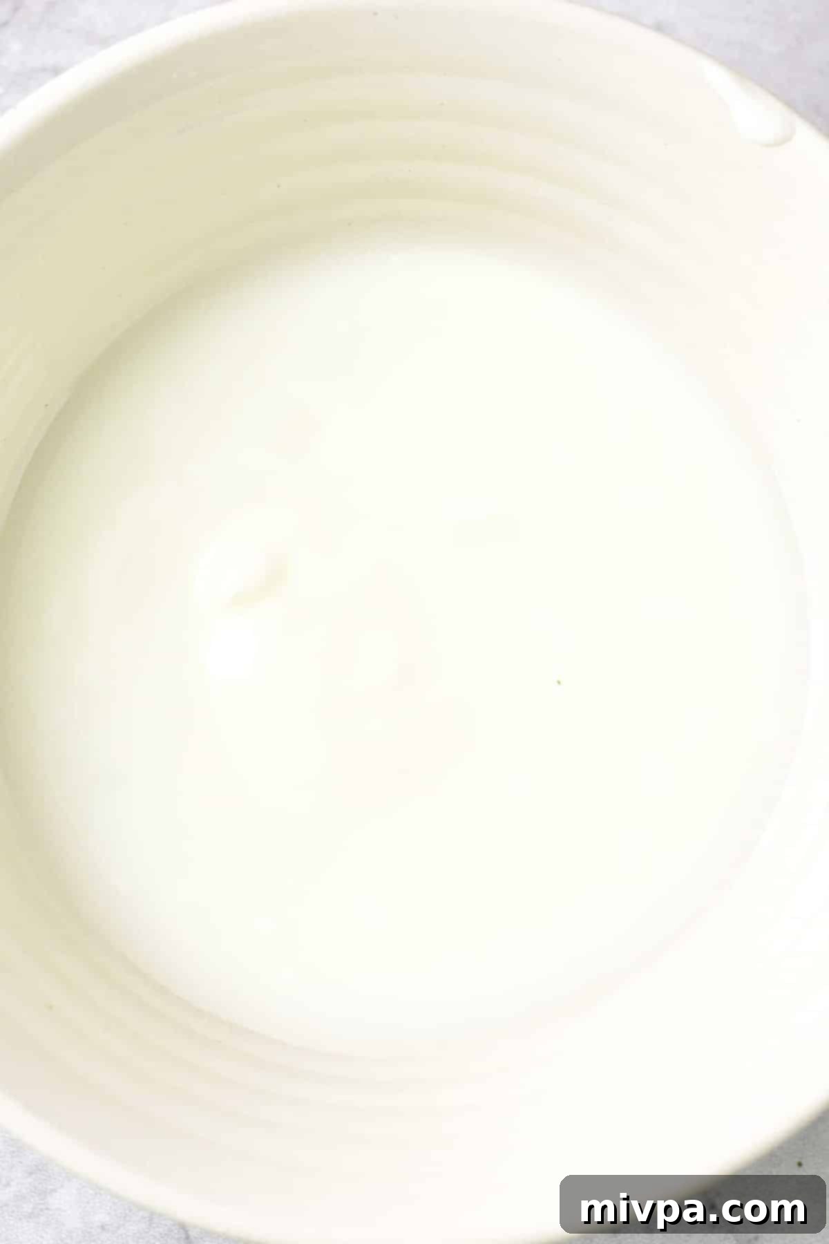Gluten free fried chicken breast recipe A bowl of creamy dairy-free buttermilk, prepared and ready for the chicken.
