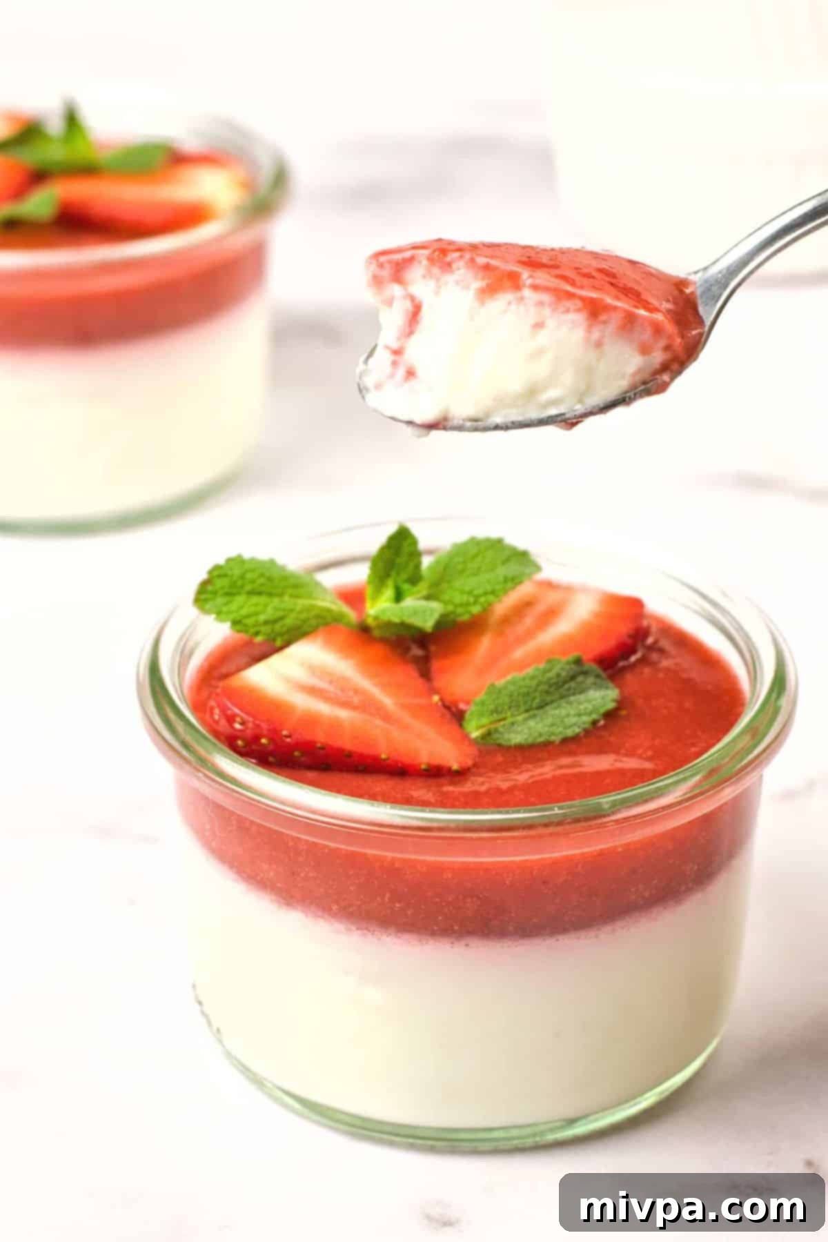 Strawberry Panna Cotta with Coconut Milk (Gluten-Free, Vegan) Scooping a spoonful of strawberry coconut panna cotta.