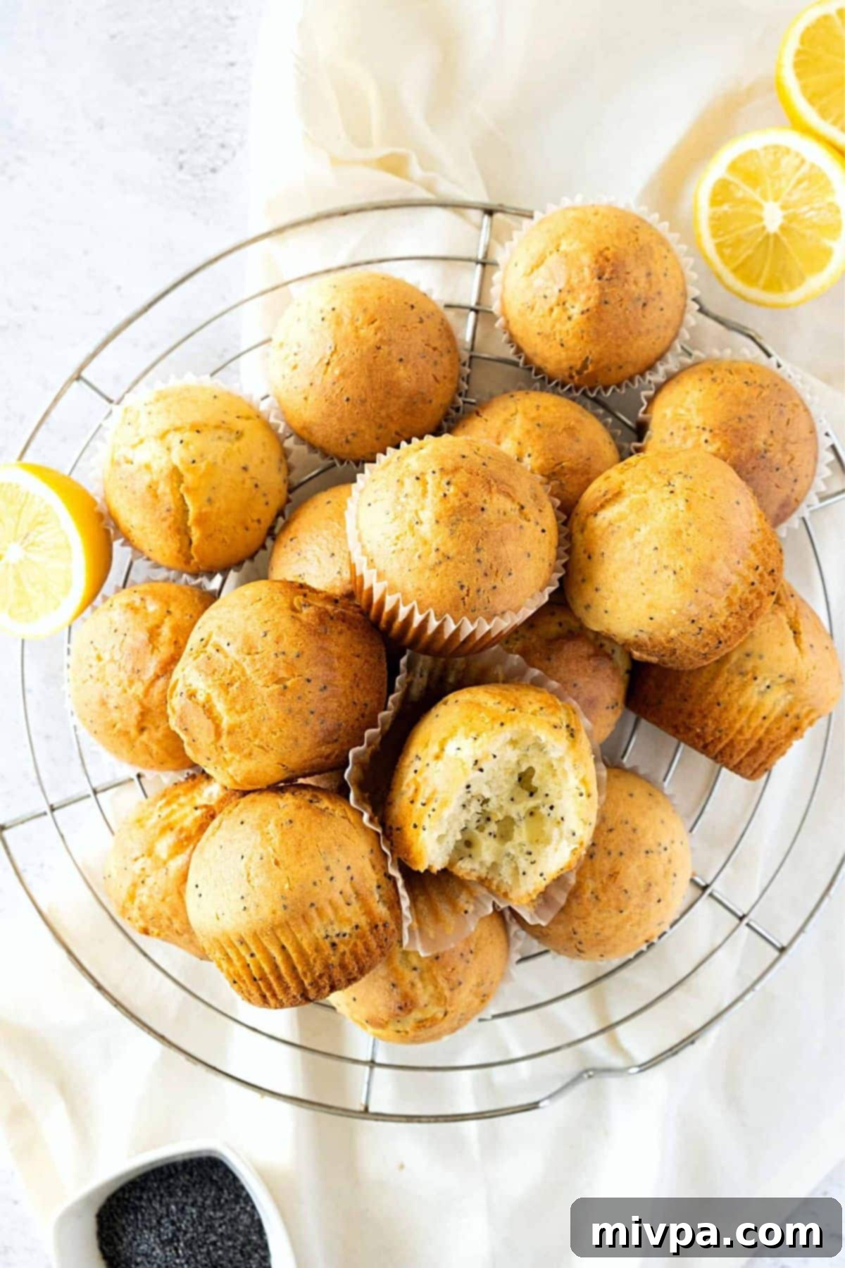 Gluten-Free Dairy-Free Lemon Poppy Seed Muffins Recipe Delicious lemon poppy seed muffins cooling evenly on a wire rack, waiting for their sweet glaze.