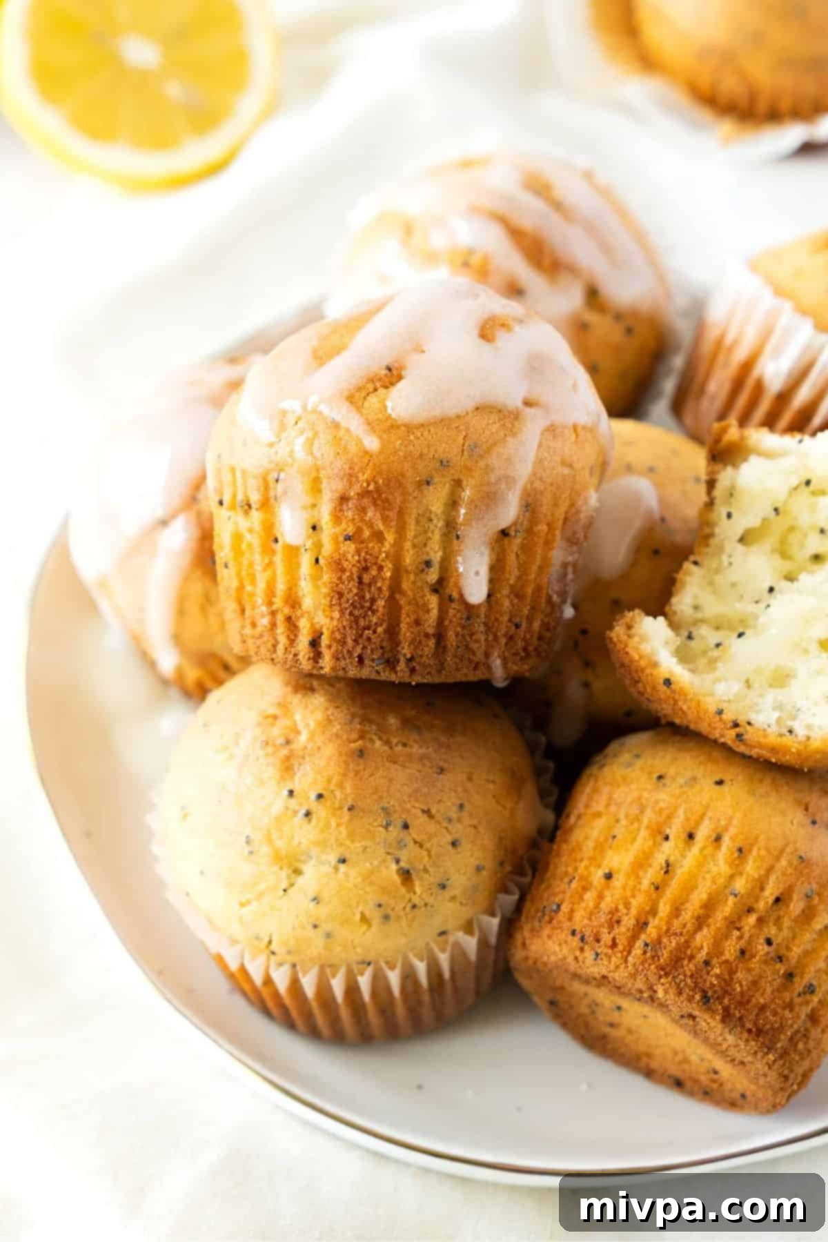GF Lemon Poppy Seed Muffins (Dairy-Free) Beautifully glazed lemon muffins with poppy seeds, showcasing their perfect golden color and moist texture.