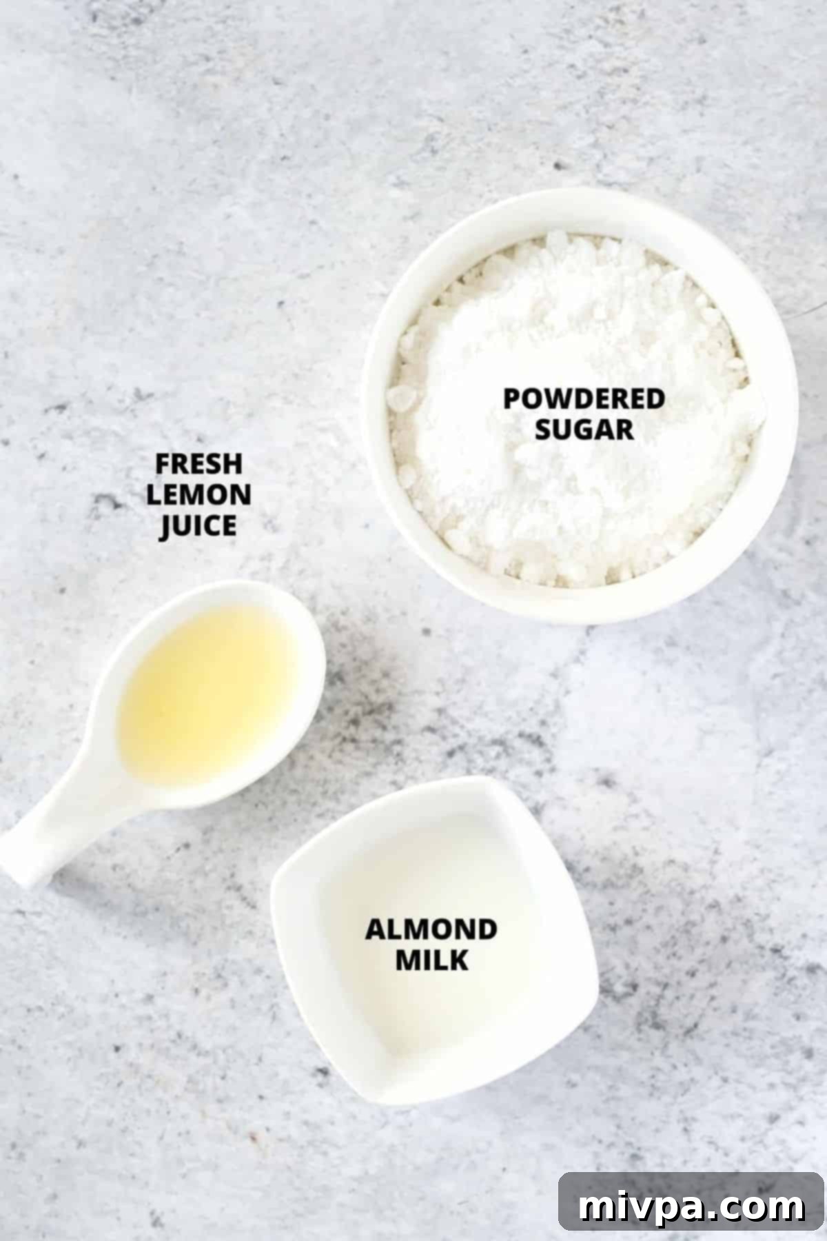 Lemon glaze Ingredients for a bright lemon glaze, including powdered sugar and fresh lemon, laid out on a cutting board.