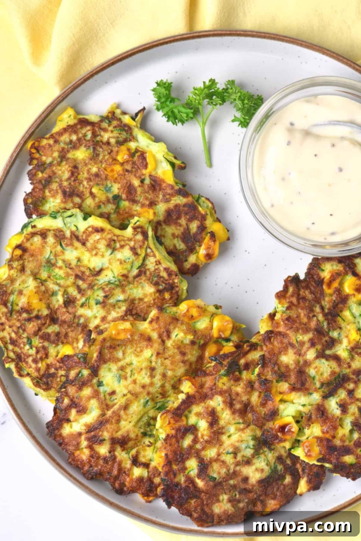 A plate full of zucchini corn fritters.
