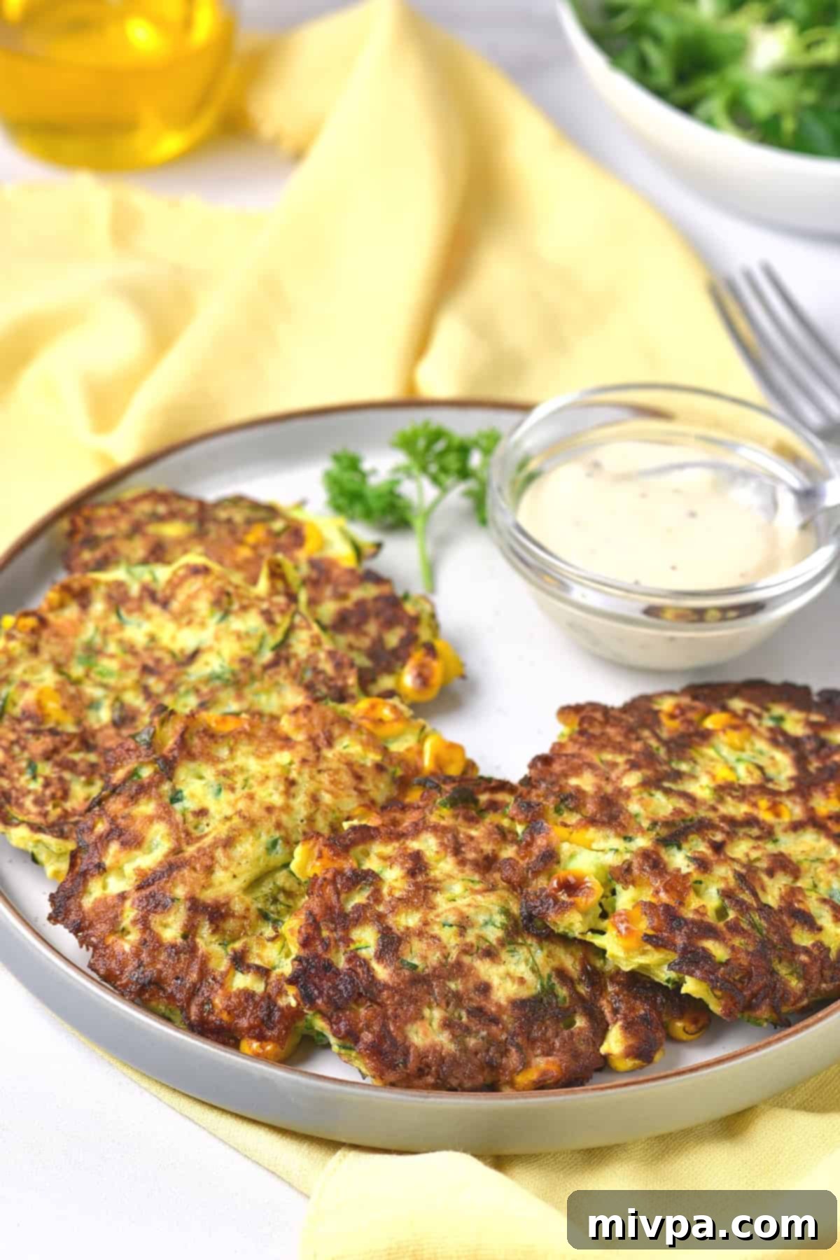 Freshly made gluten-free zucchini fritters ready to be served.