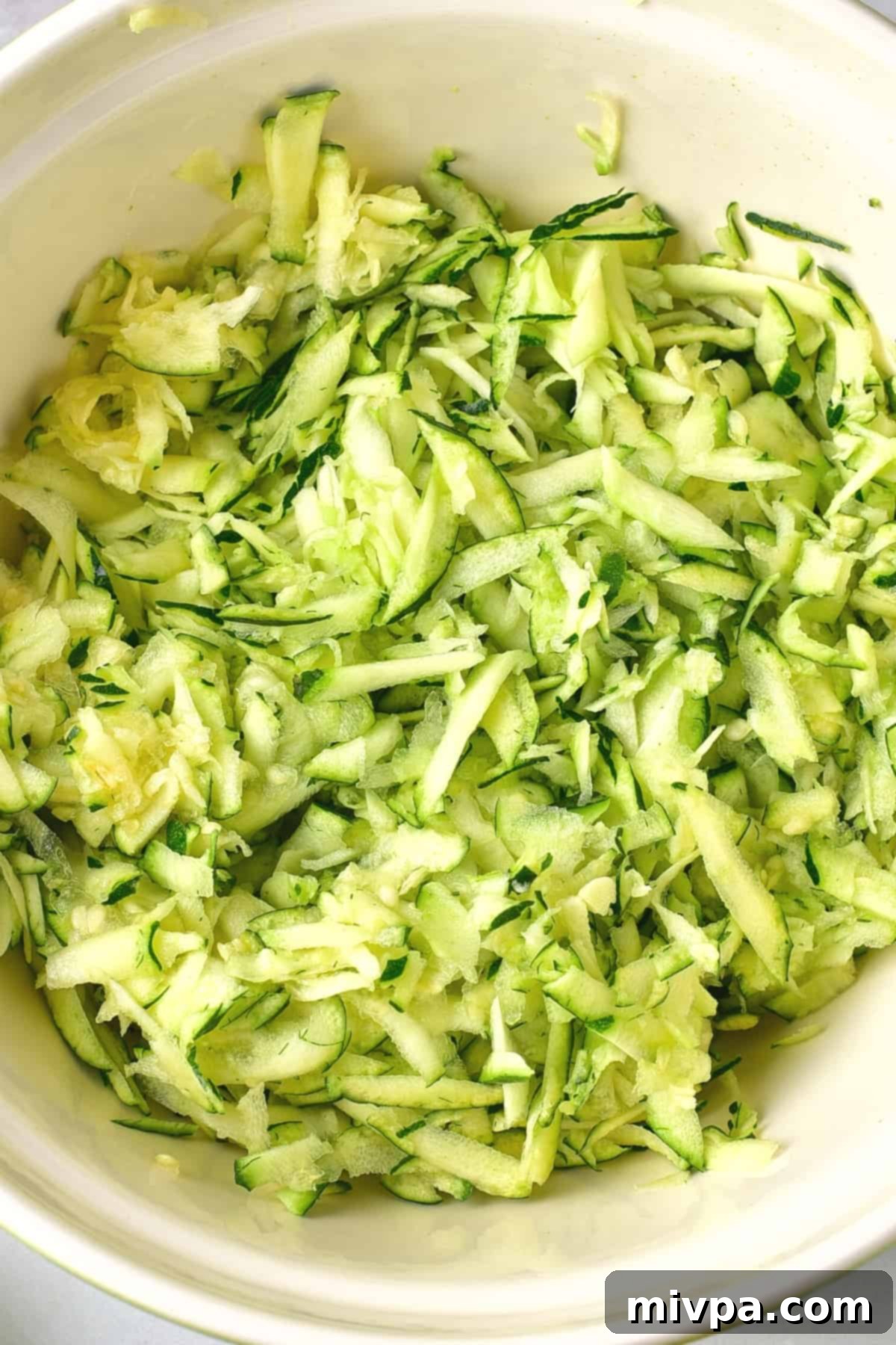 A bowl of grated zucchini.