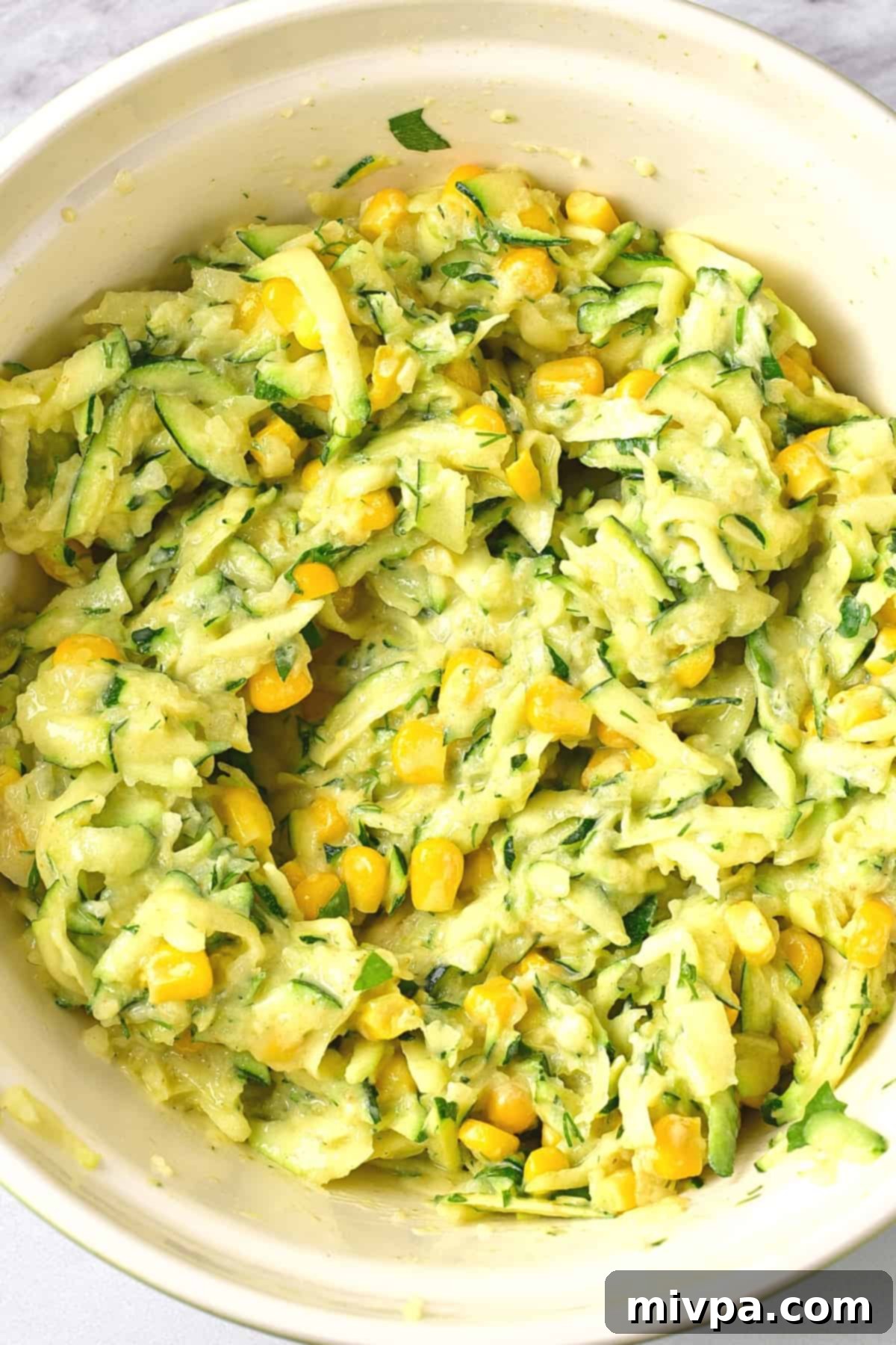 Zucchini and corn mixture in bowl.