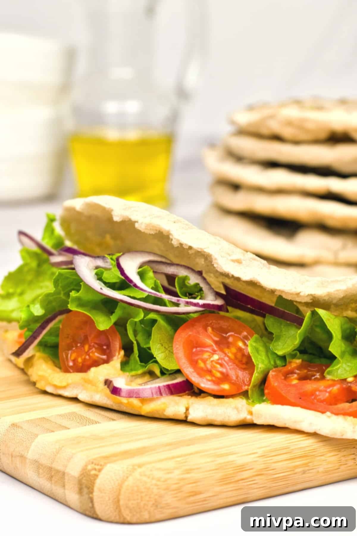 Gluten-Free Dairy-Free Pita Bread Recipe (Vegan) Colorful fresh veggies and falafel tucked inside a perfectly formed gluten-free pita pocket.