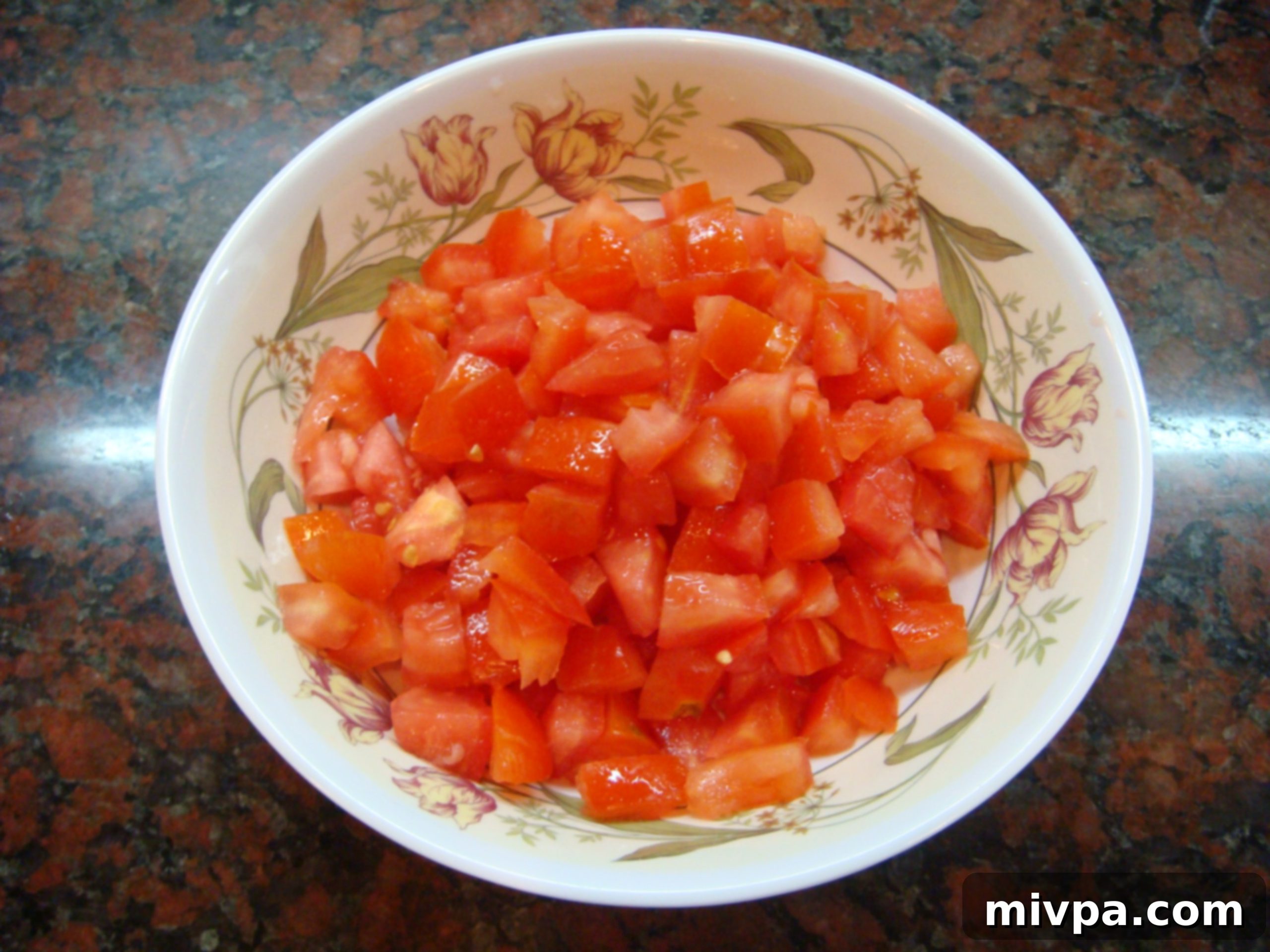 Finely Chopped Tomatoes A pile of freshly chopped red tomatoes, diced into small, uniform pieces, ready for the topping.