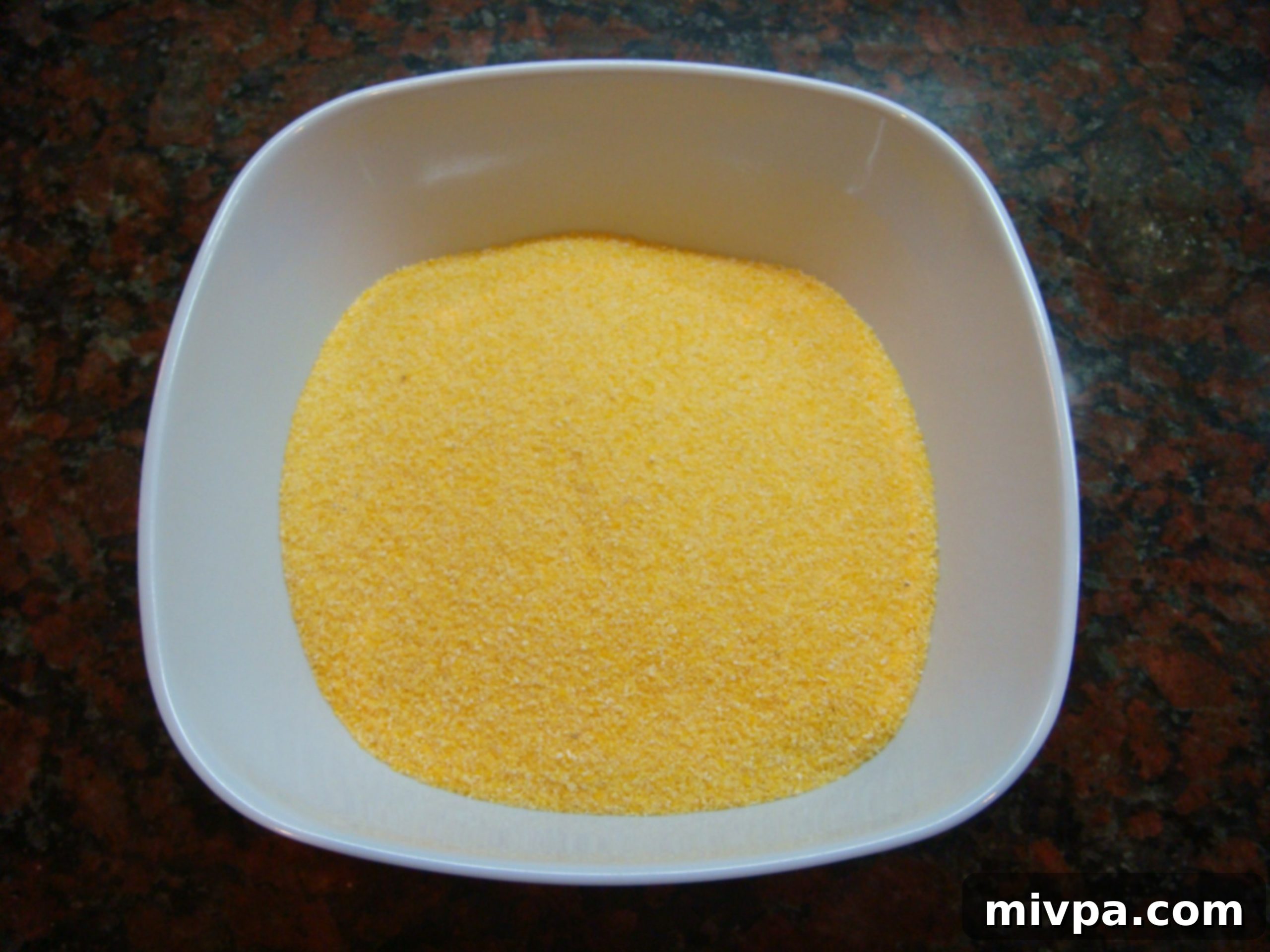 Instant Polenta Mix Ready A bag of instant polenta mix, showing the fine yellow cornmeal texture, ready for preparation.