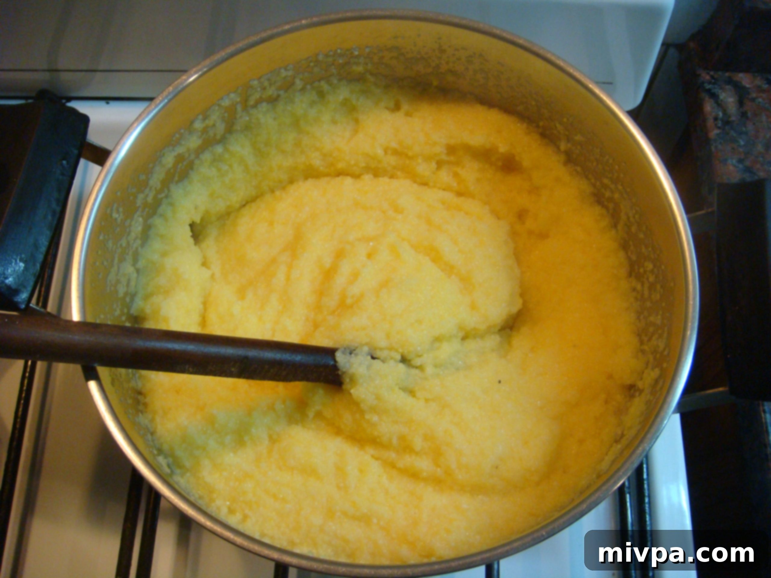 Polenta Desired Consistency A pot of cooked polenta, now thick and creamy, having reached the desired consistency.