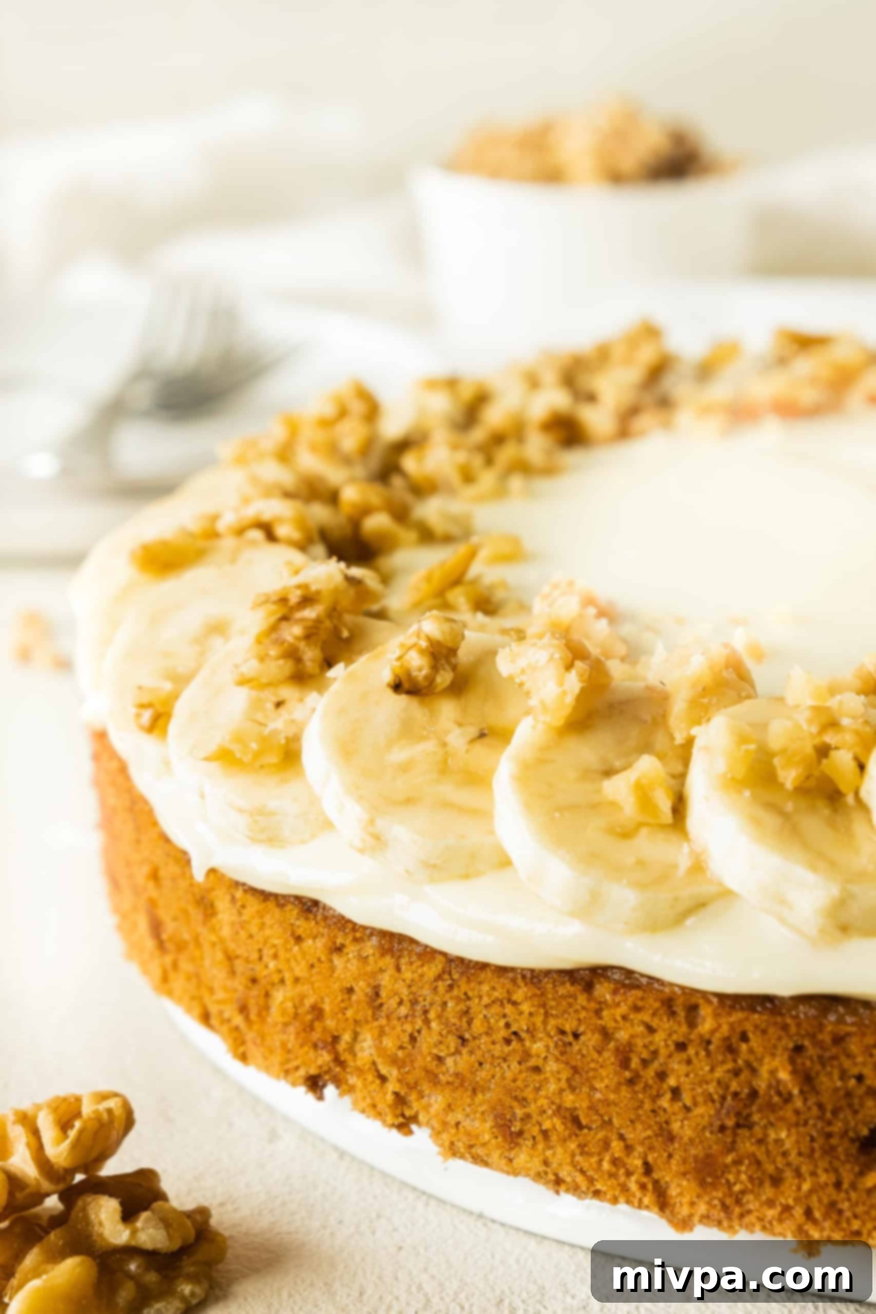 Easy Gluten-Free Banana Cake Recipe (Dairy-Free) Up close shot of gluten-free banana cake with cream cheese frosting.