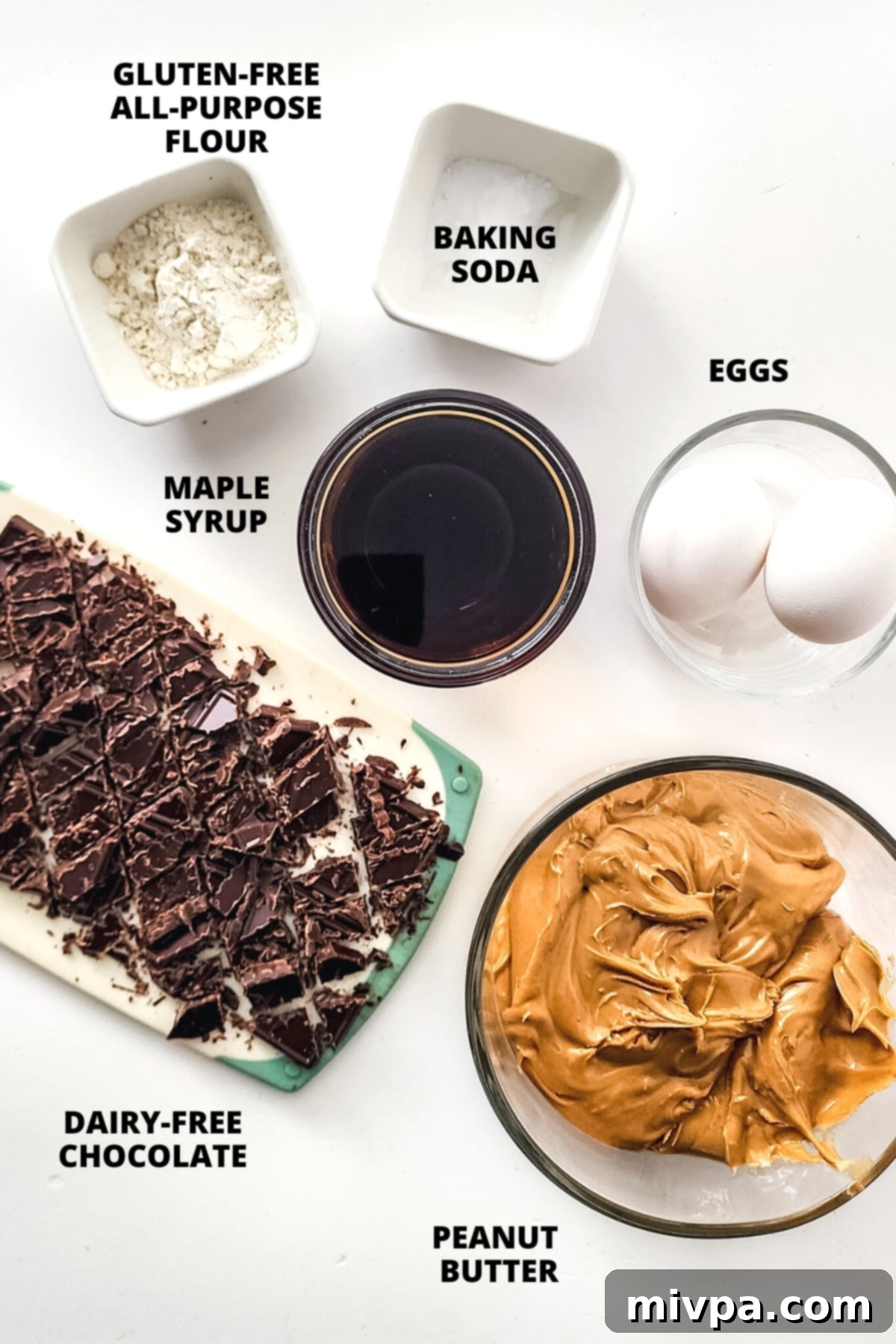 All the necessary ingredients for the gluten-free peanut butter blondie recipe neatly laid out on a wooden board.