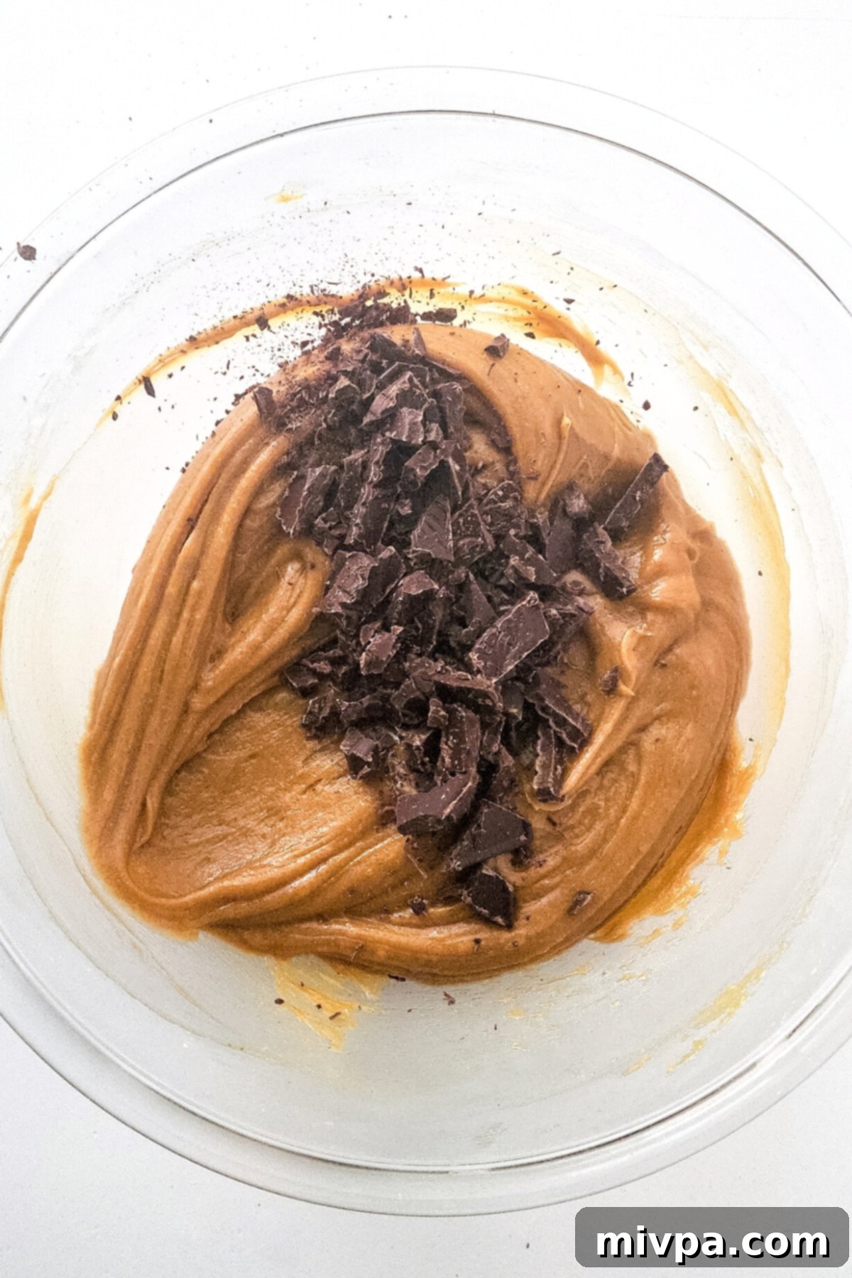 Chopped dairy-free chocolate pieces folded into the thick peanut butter blondie batter.