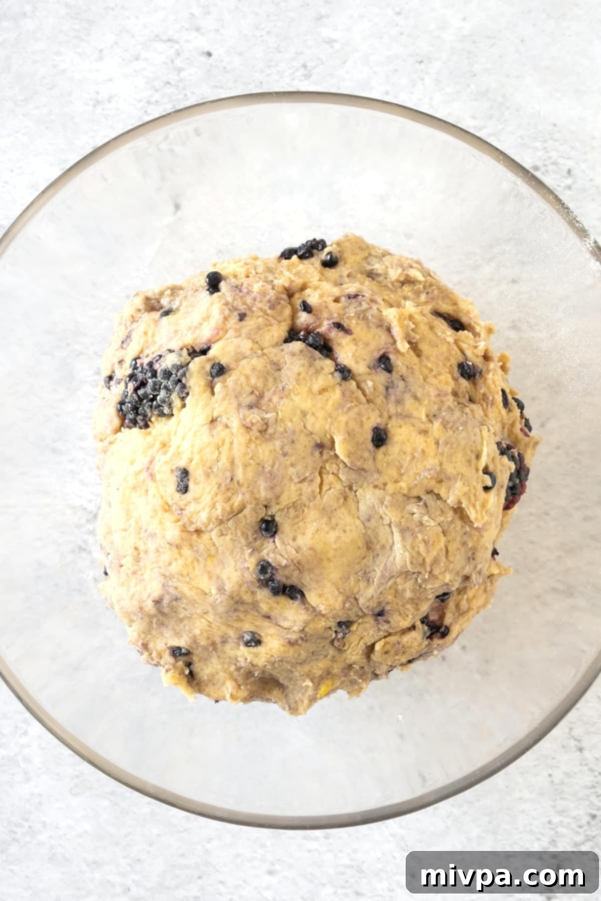 Blackberry Scones (Gluten-Free, Dairy-Free) Dough Ball A round ball of blackberry scone dough on a surface.