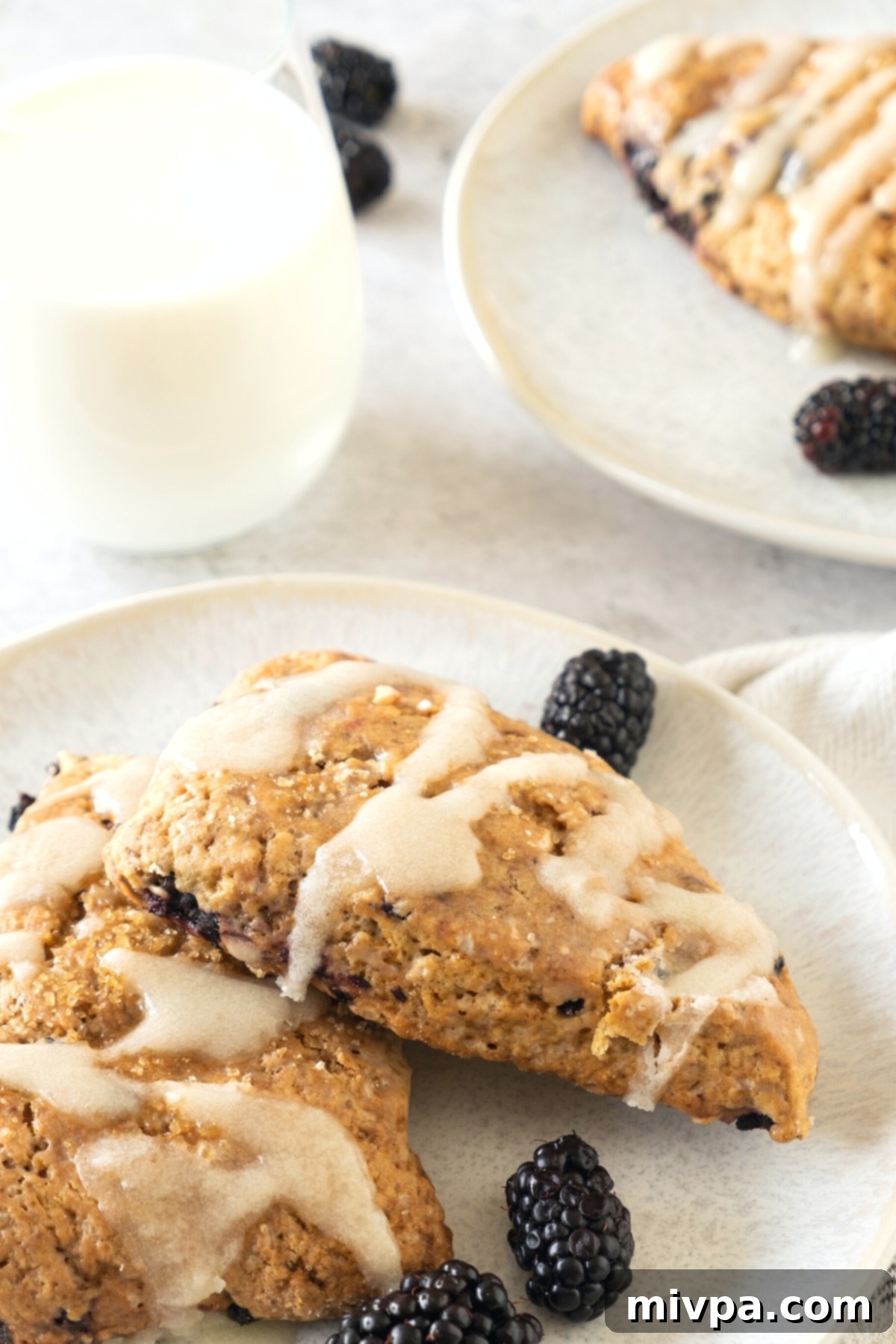 Gluten-Free Blackberry Scones (Dairy-Free) Serving Suggestion A plate of gluten-free blackberry scones next to a glass of dairy-free milk.