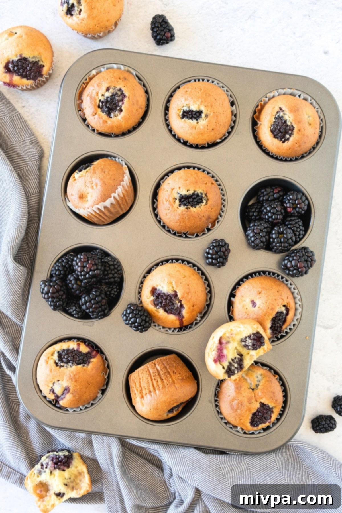 Blackberry gluten-free muffins in a muffin tin.