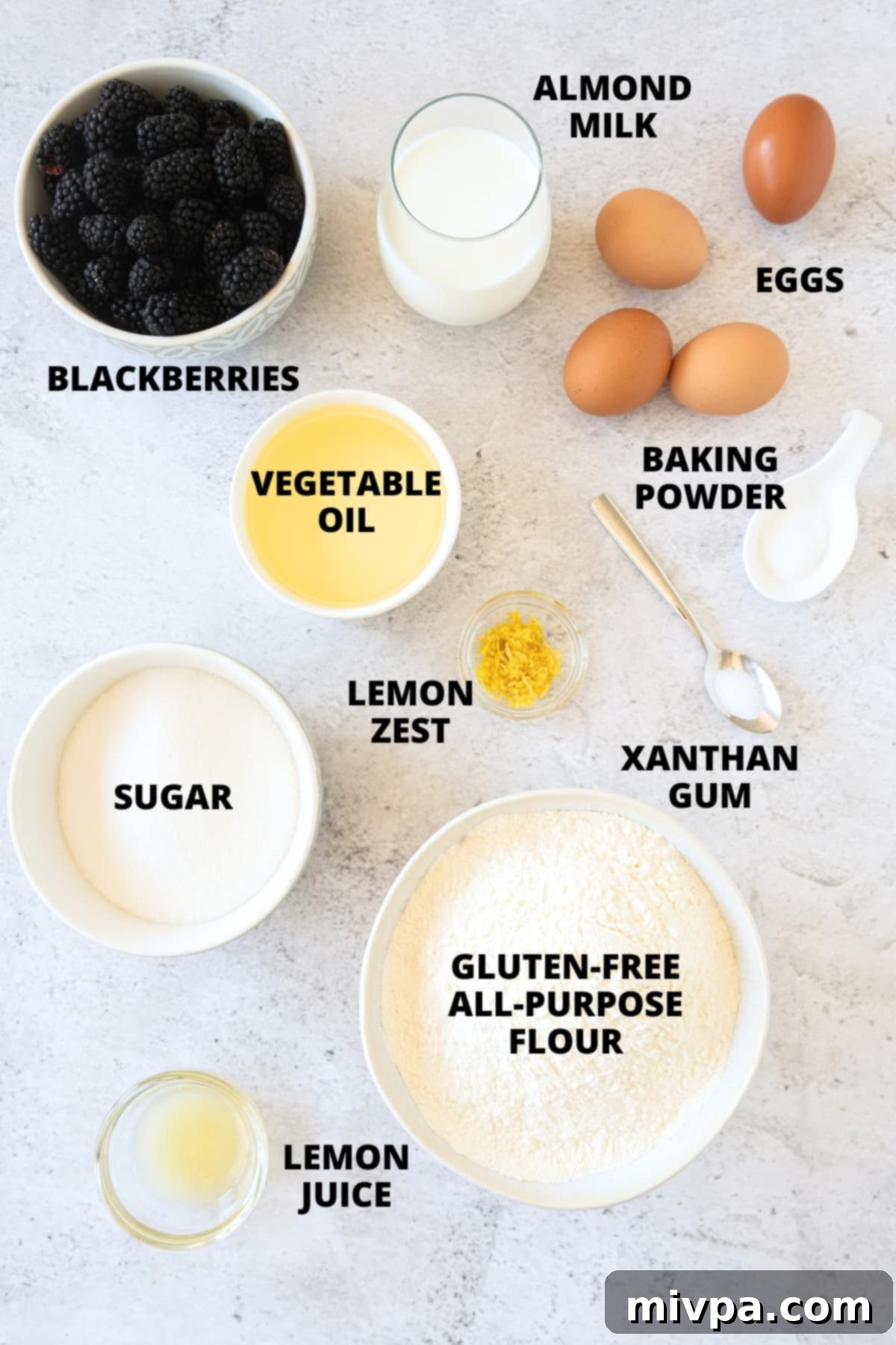 Ingredients for gluten-free blackberry muffins recipe laid out on board.