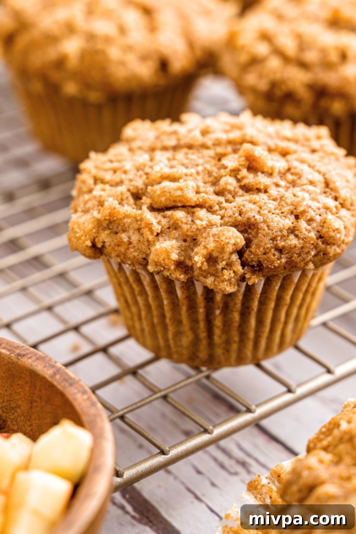 GF applesauce muffins on wire rack.