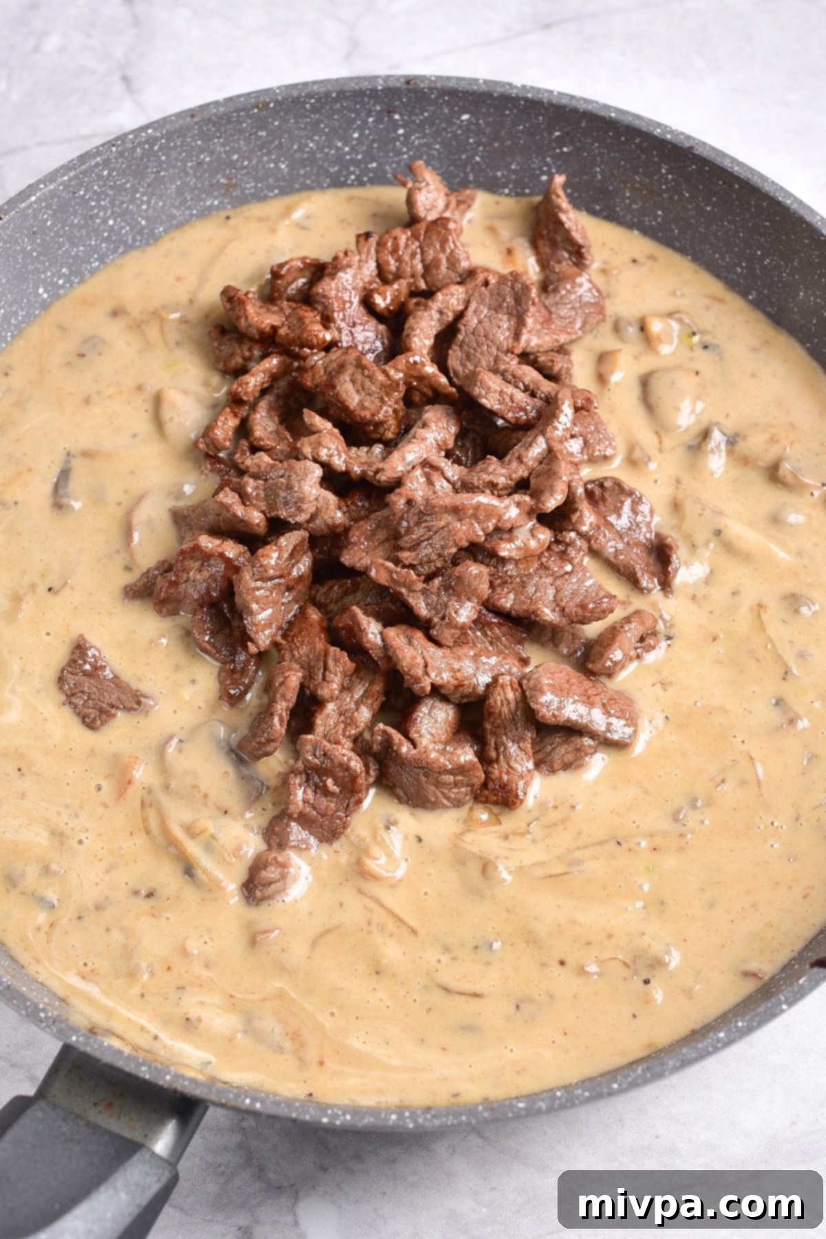 Gluten-Free Dairy-Free Beef Stroganoff Recipe Cooked beef slices on top of mushroom sauce.