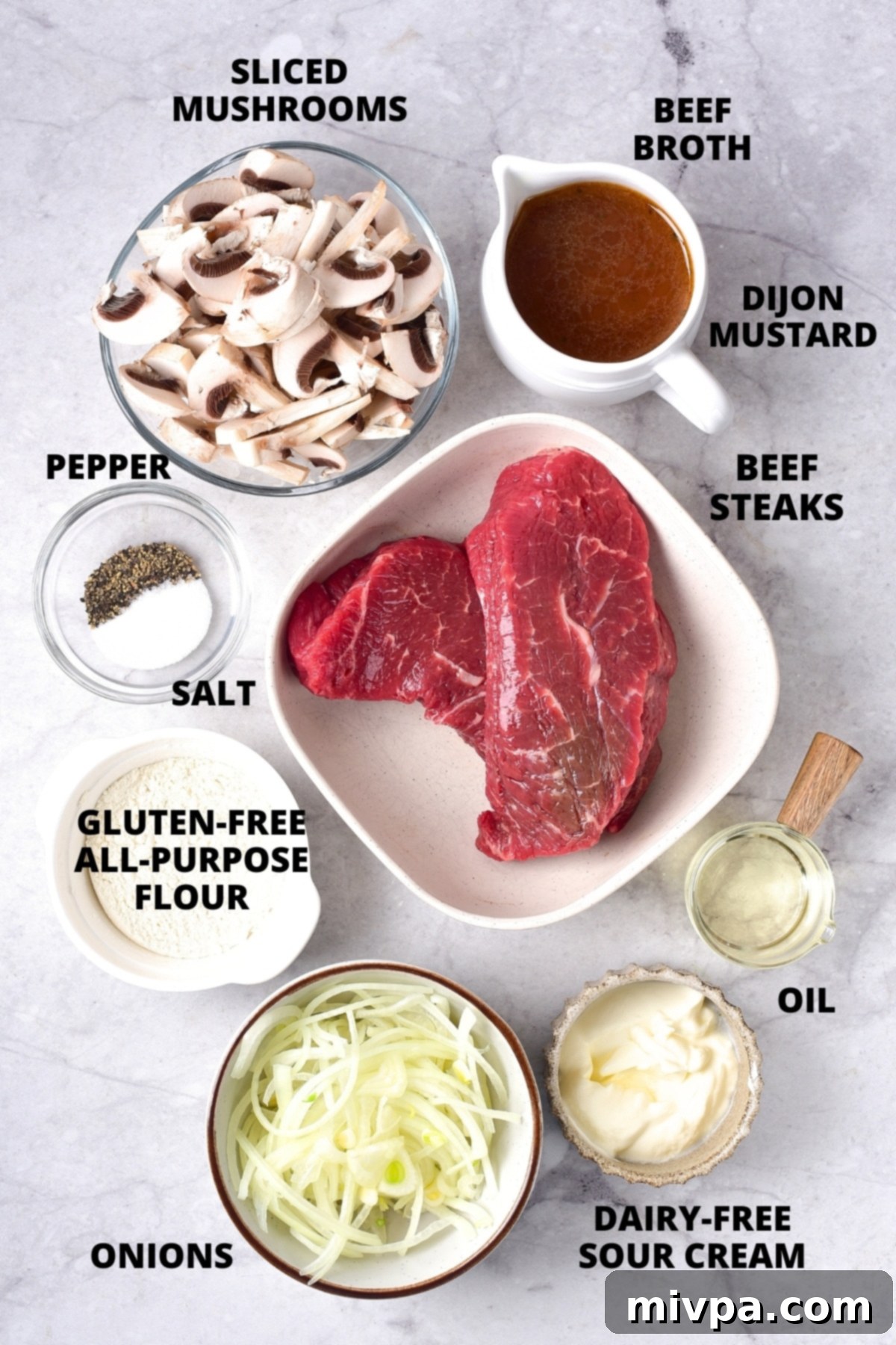 Gluten-Free Beef Stroganoff Recipe (Dairy-Free) Ingredients for gluten-free beef stroganoff recipe laid out on marble board.