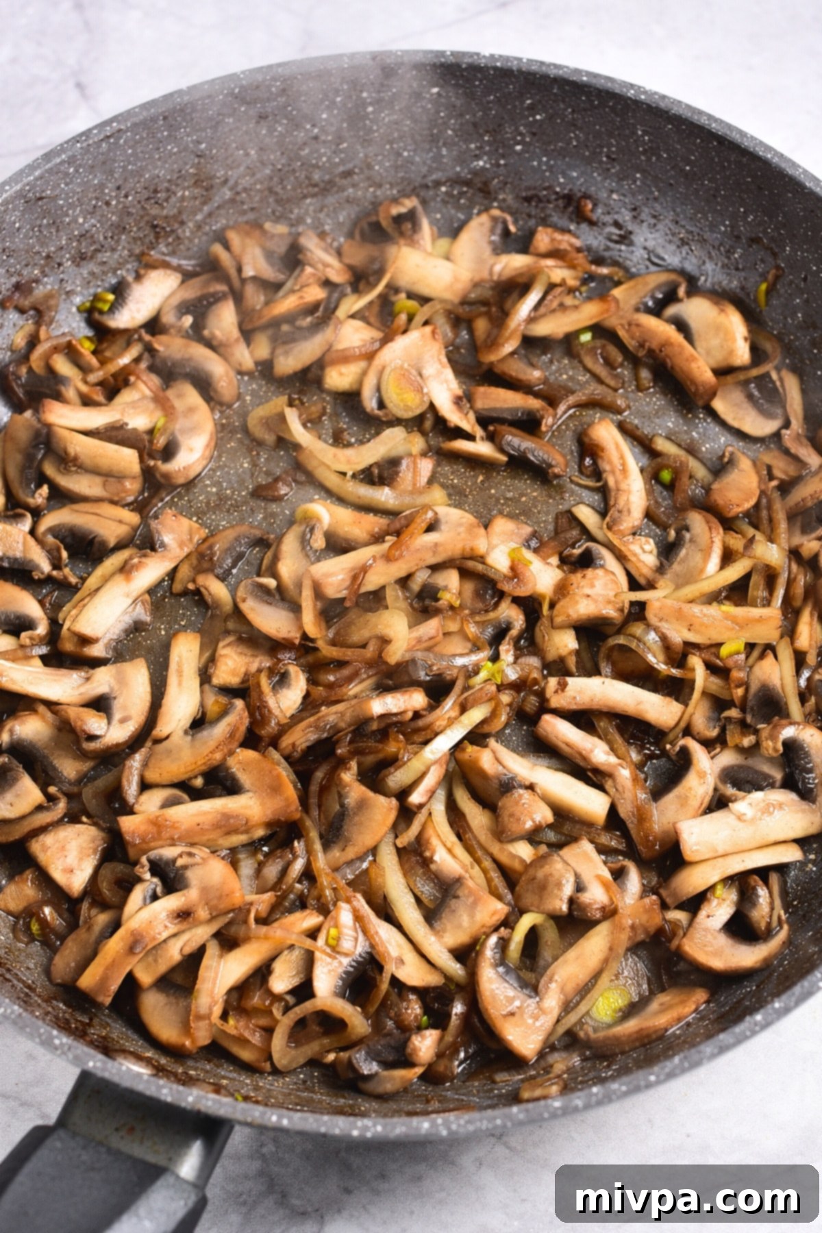 Gluten and Dairy Free Beef Stroganoff Recipe Sautéed mushroom slices in skillet