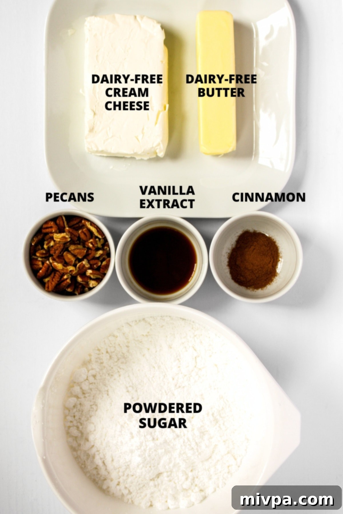 Ingredients for the dairy-free cream cheese frosting recipe laid out on a white board.