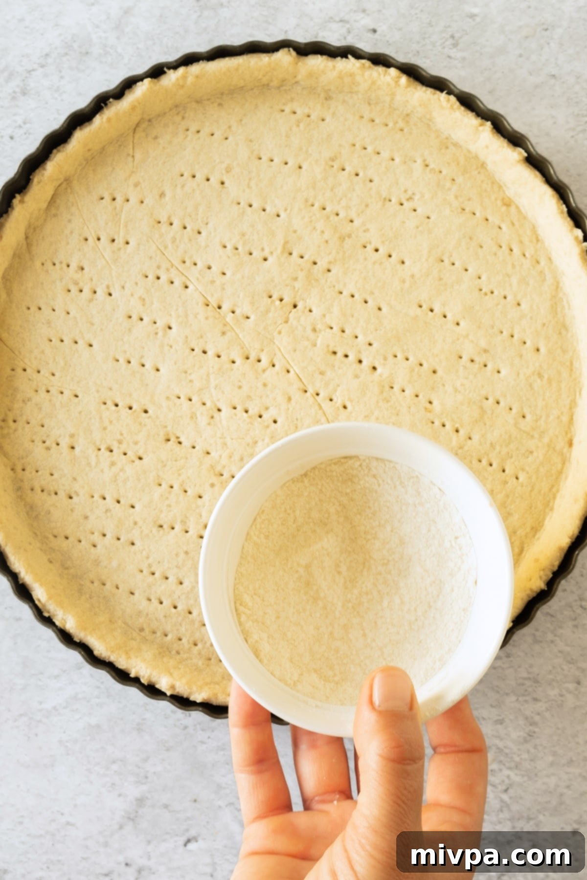 Perfect Apple Tart for Everyone 2 Sugar and flour mixture sprinkled on par-baked tart crust.