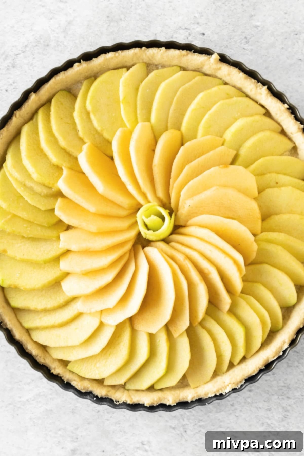 French Apple Tart (Gluten-Free, Dairy-Free) Sliced apples arranged beautifully in a par-baked tart crust.