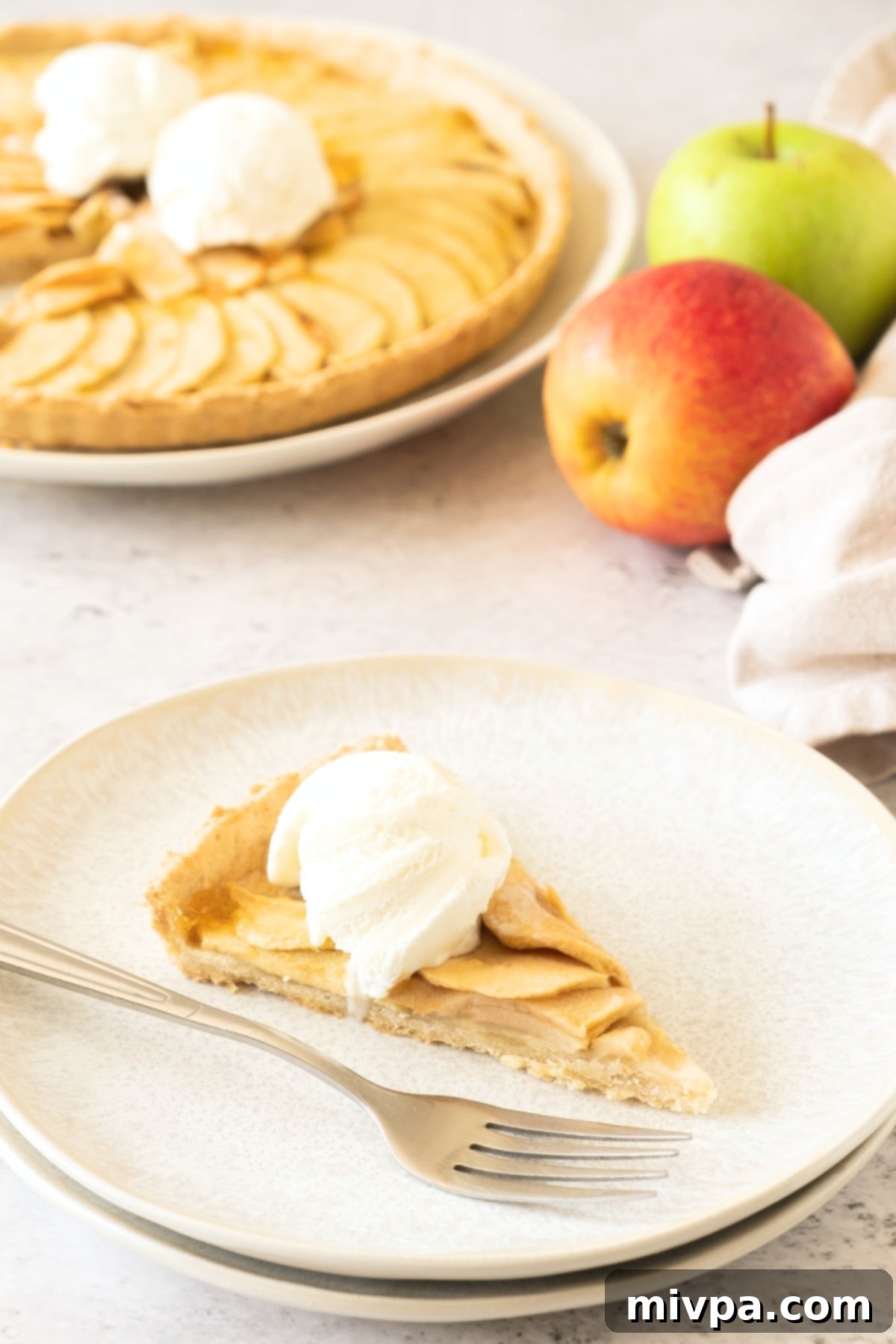 Gluten-Free Dairy-Free Apple Tart A slice of gluten-free dairy-free apple tart on plate.