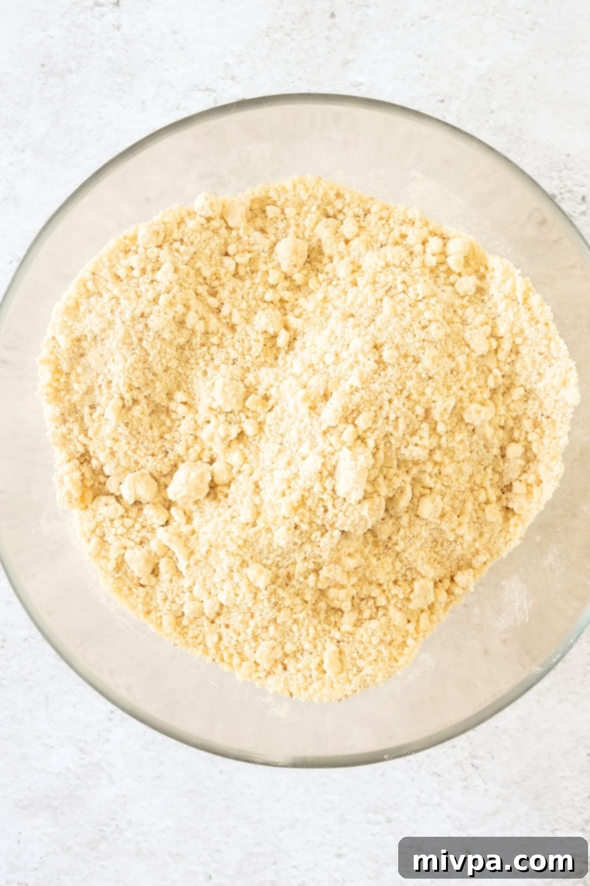 Gluten-Free Apple Tart Recipe (Dairy-Free) Flour mixture with butter crumbs in a glass bowl.