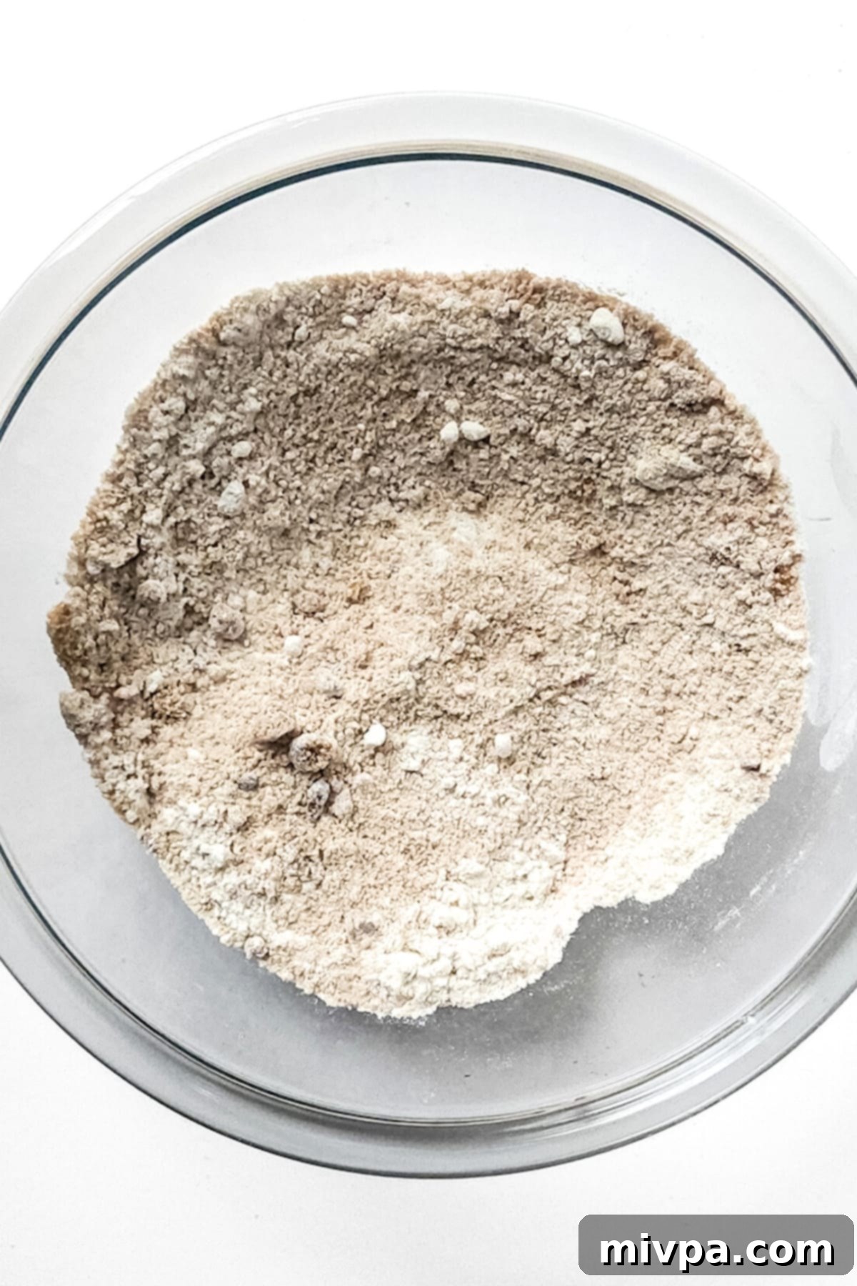 Gluten-Free Apple Bread Recipe (Vegan) Flour and brown sugar mixture in a bowl, ready for the next step of the crumble topping.