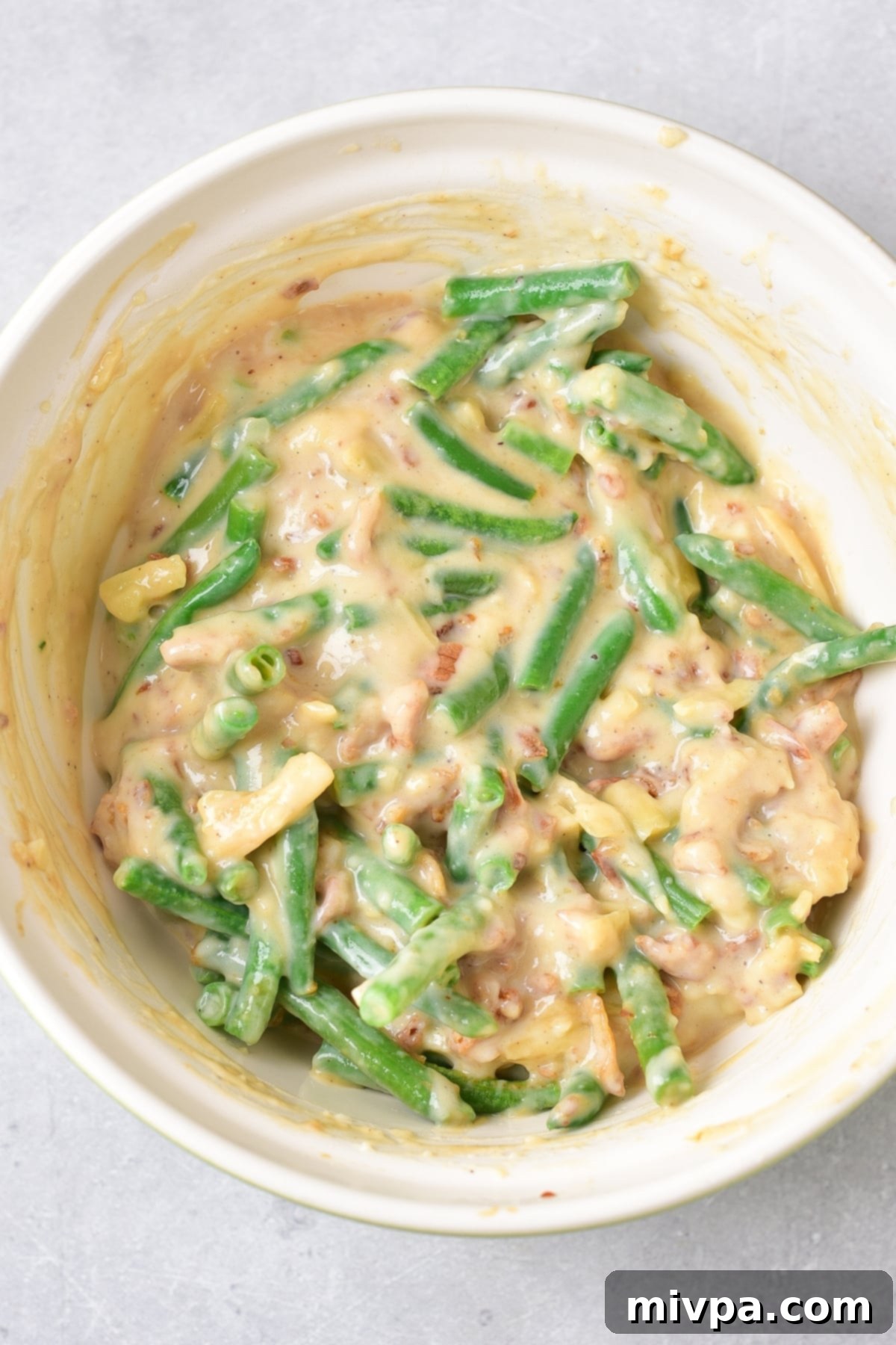 Green bean mixture in white bowl.
