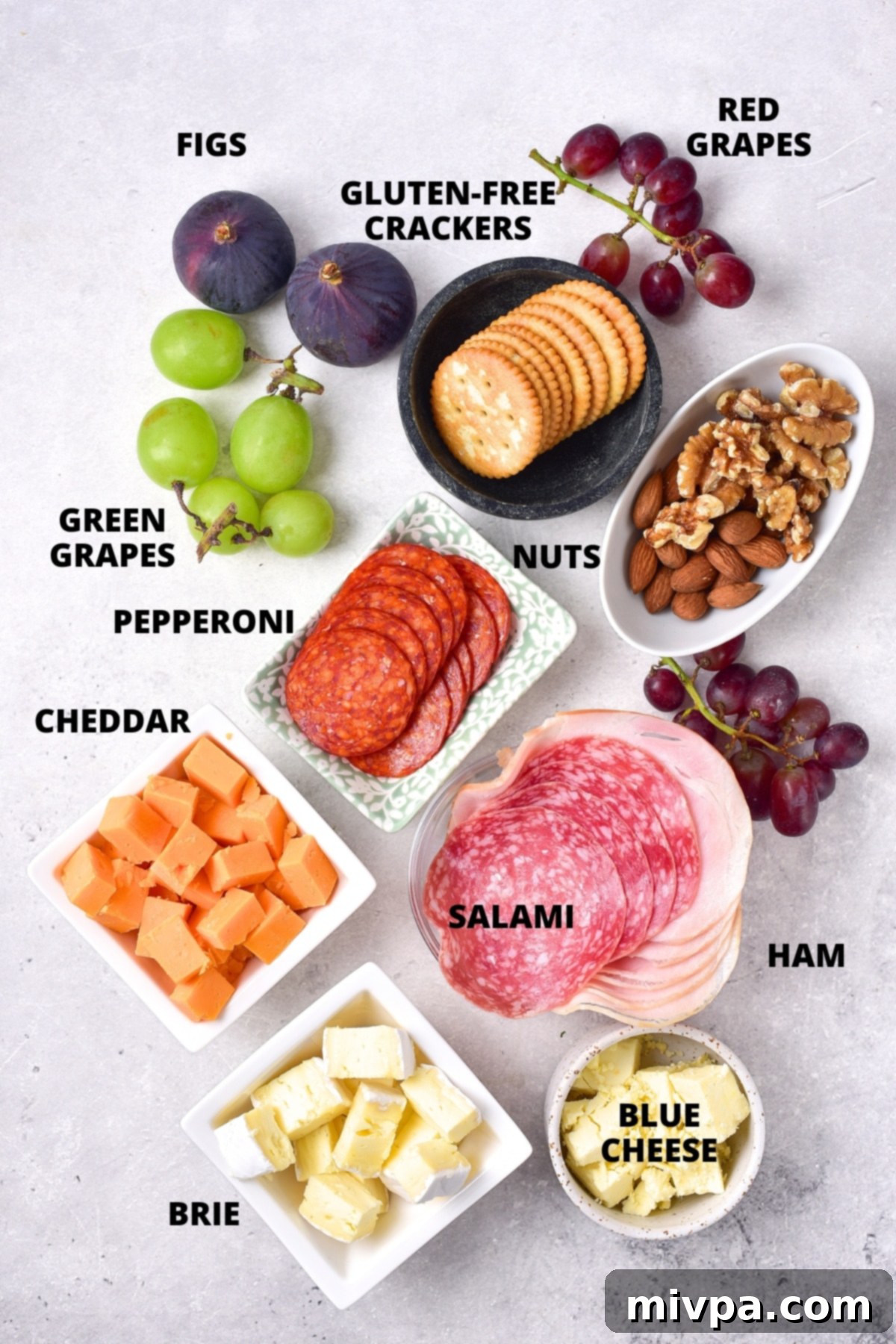 Ingredients for charcuterie board laid out on board.