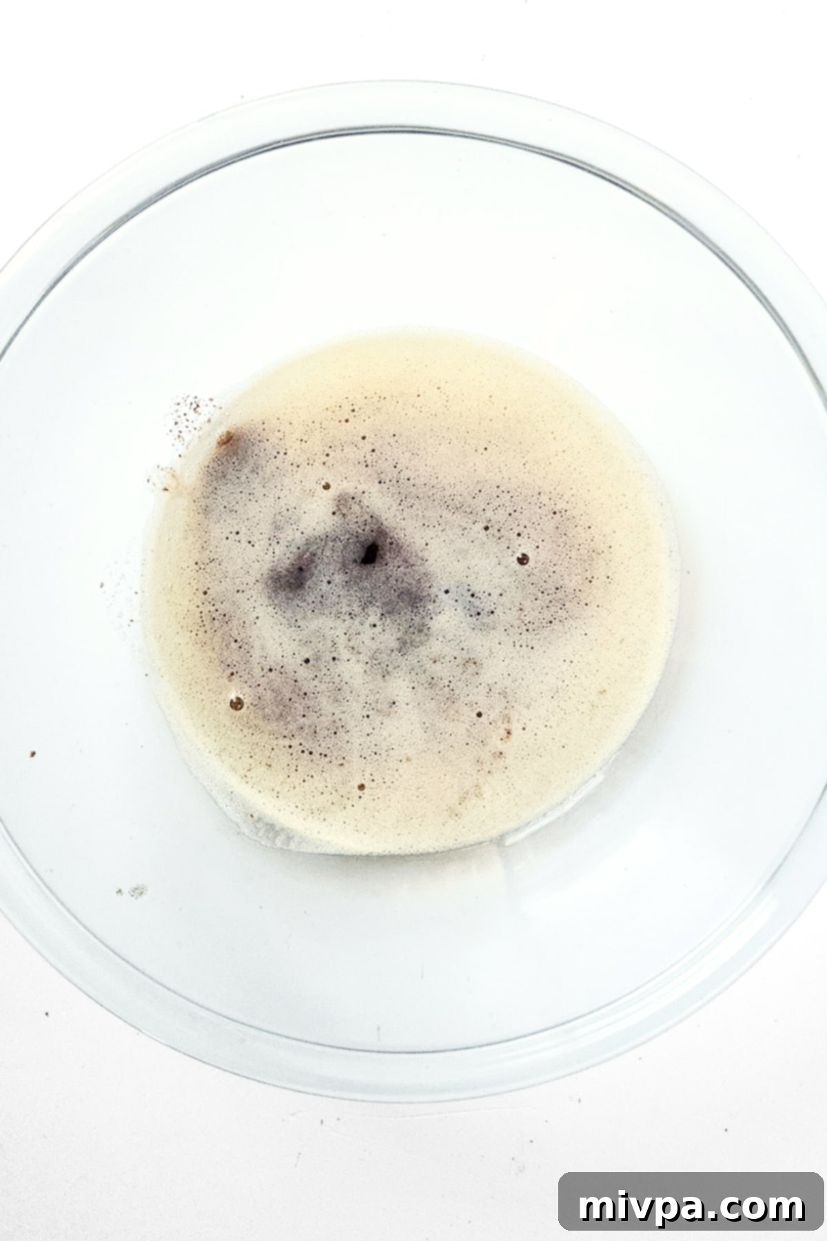 Rich, golden-brown melted butter in a clear glass bowl, ready for the next steps in the recipe.