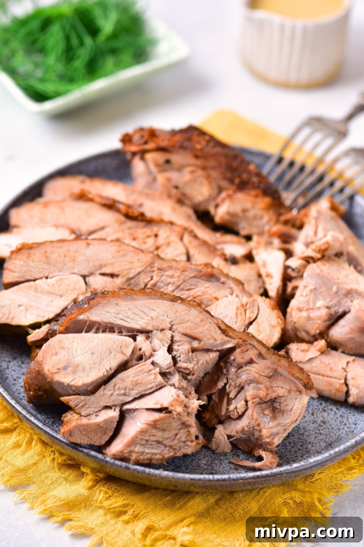 Oven Roasted Turkey Thighs (Gluten-Free, Dairy-Free) Up close view of succulent, sliced turkey thighs with crispy skin.