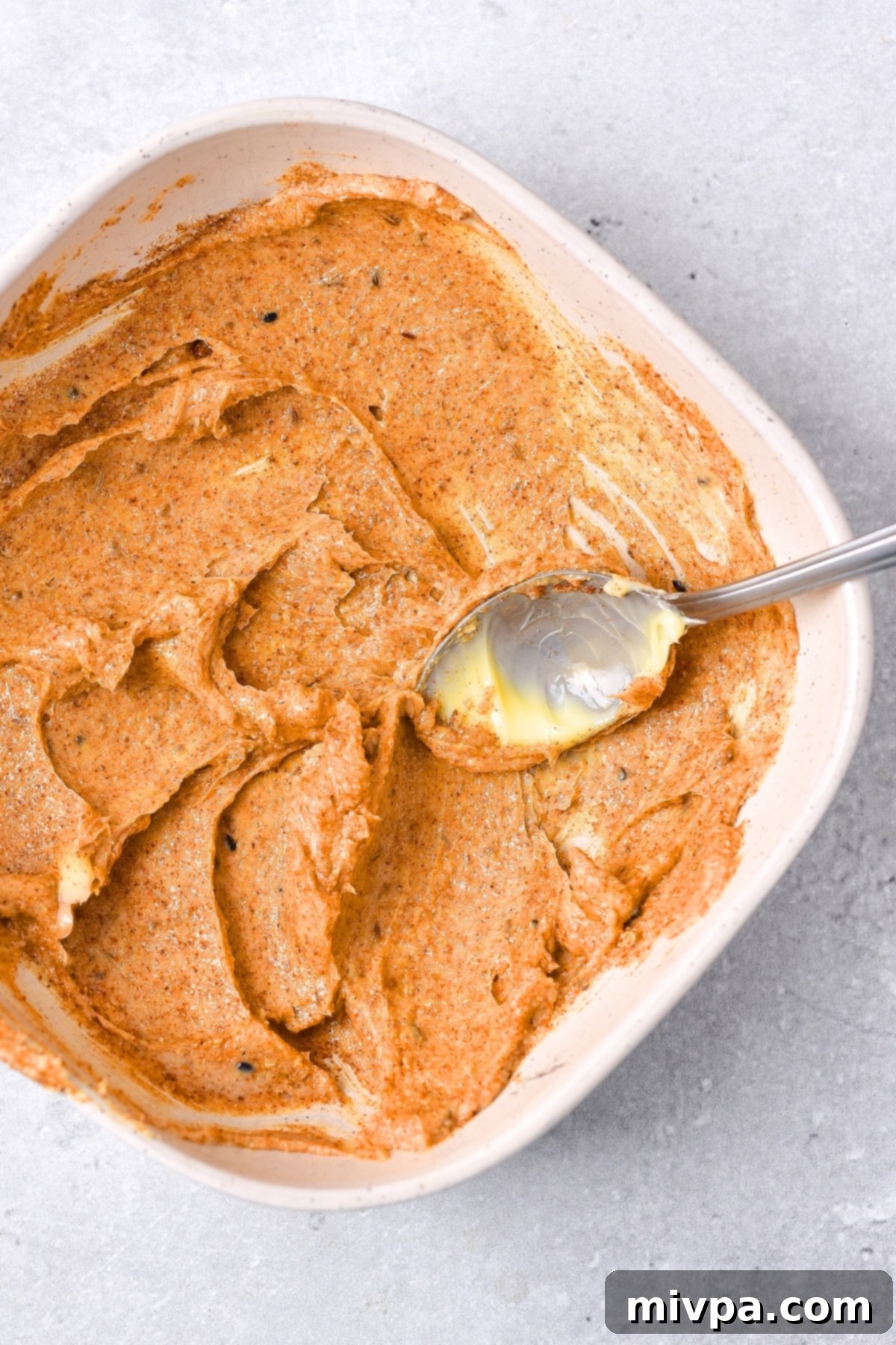 Easy Oven Roasted Turkey Thighs (Gluten-Free, Dairy-Free) Butter and condiments mixed in a bowl, creating a flavorful seasoning paste.