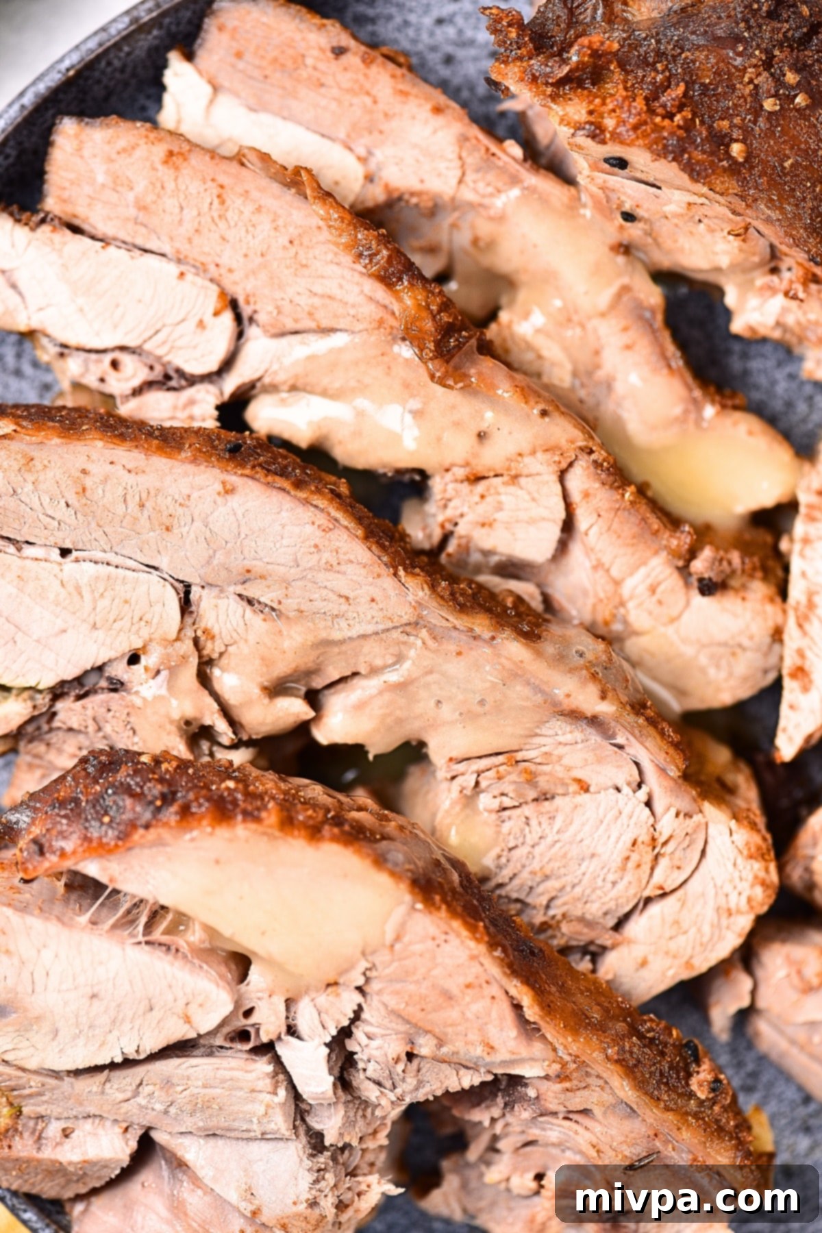 How to roast turkey in oven Rich turkey gravy drizzled over perfectly sliced roasted turkey thighs.