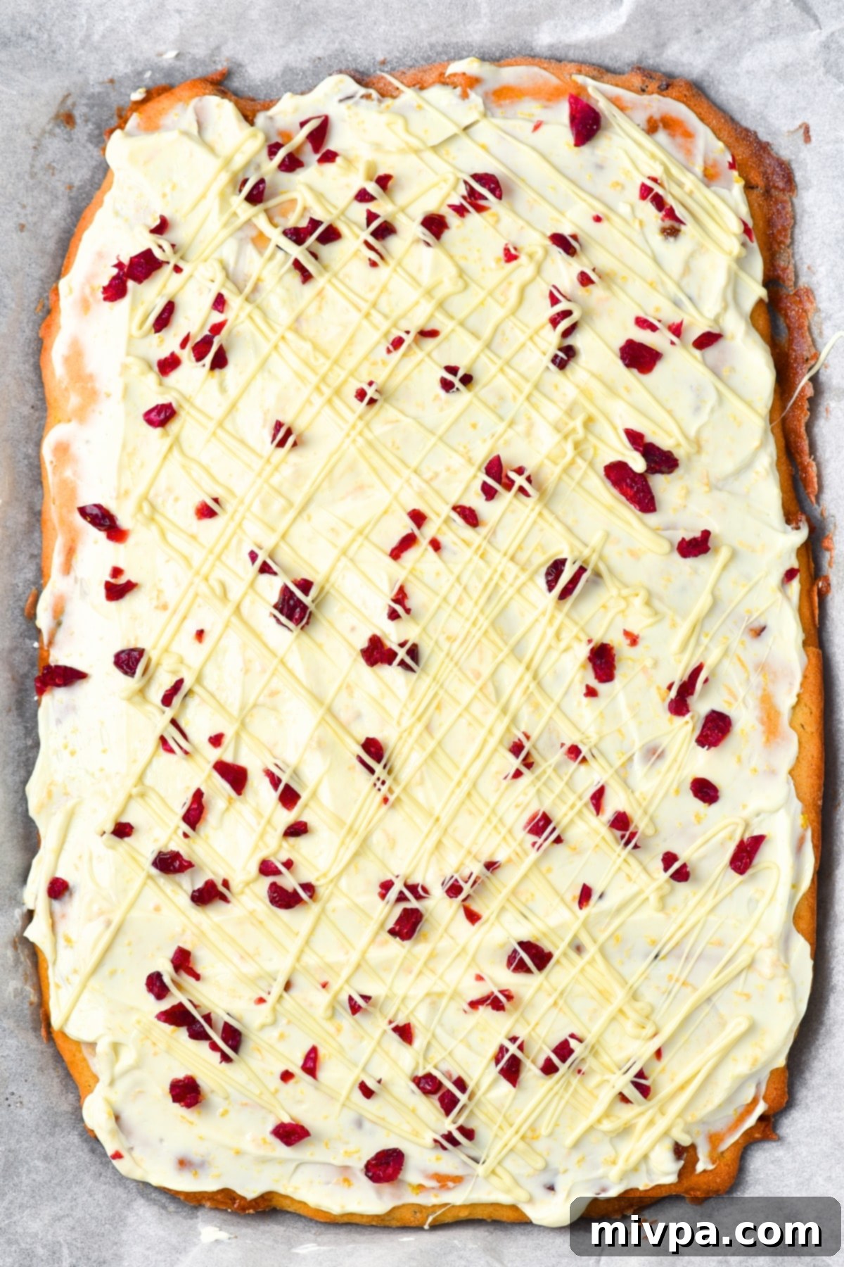Gluten-Free Cranberry Bliss Bars Recipe (Dairy-Free Drizzle) Elegant white chocolate drizzle over the cranberry-frosted cake, completing the classic cranberry bliss bar look.