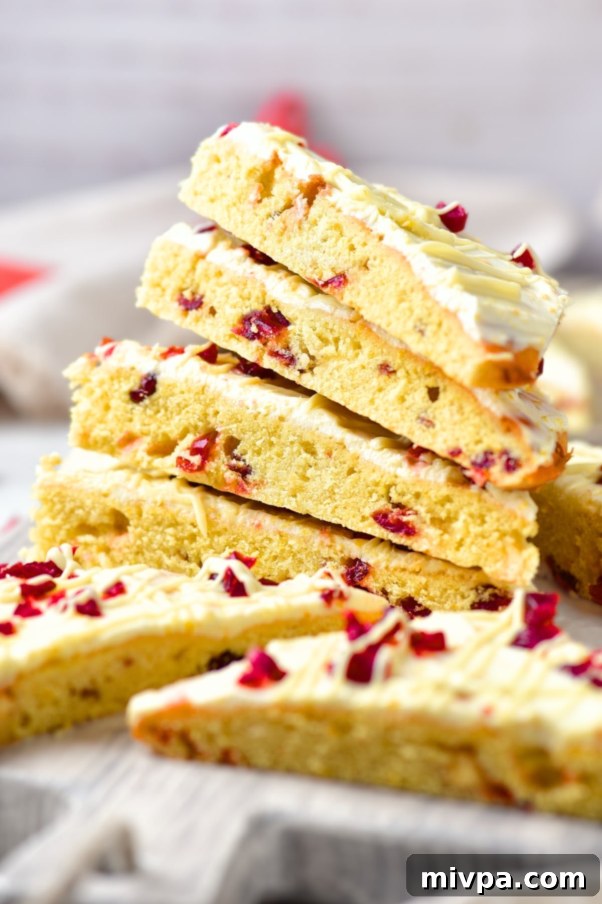 GF Copycat Starbucks Cranberry Bliss Bars (Dairy-Free Stack) A beautiful stack of gluten-free cranberry bliss bars, showing off their generous frosting and vibrant cranberry topping, ready to be enjoyed.