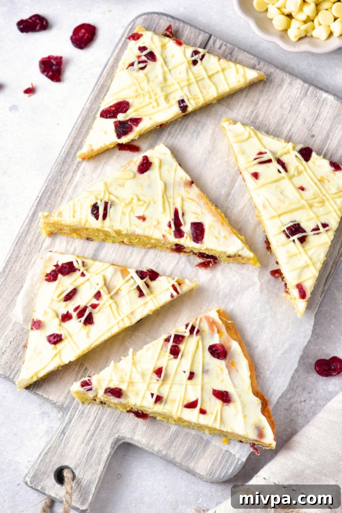 Homemade Cranberry Bliss Bars (Gluten-Free, Dairy-Free Copycat) Top-down view of beautifully arranged gluten-free cranberry bliss bars on a rustic wooden board, showcasing their festive appeal.