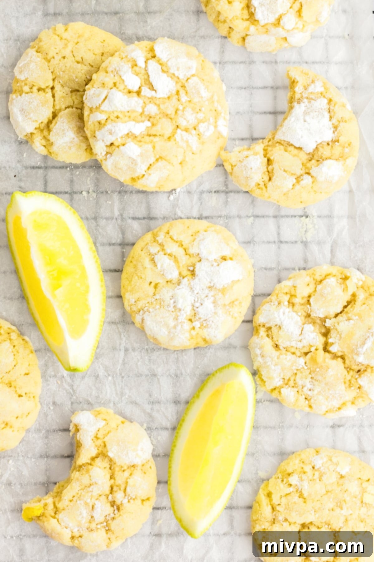 Top down view of gluten-free lemon crinkle cookies on parchment.