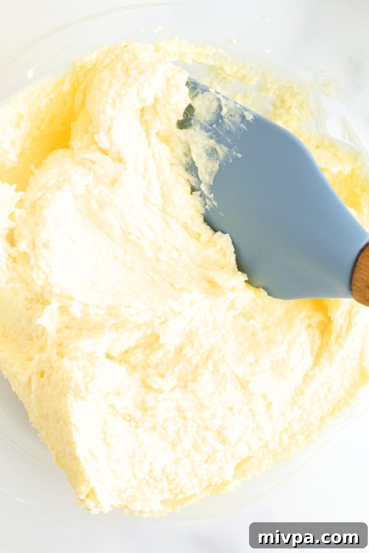 Mixing butter-sugar mixture in bowl.