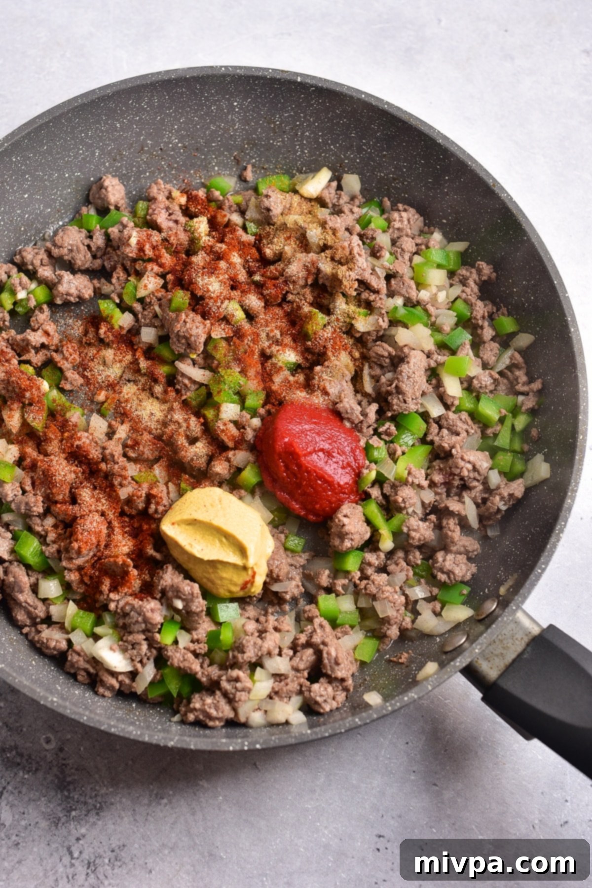 Gluten-Free Sloppy Joes (Dairy-Free) Tomato paste and mustard and condiments on top of cooked ground beef.